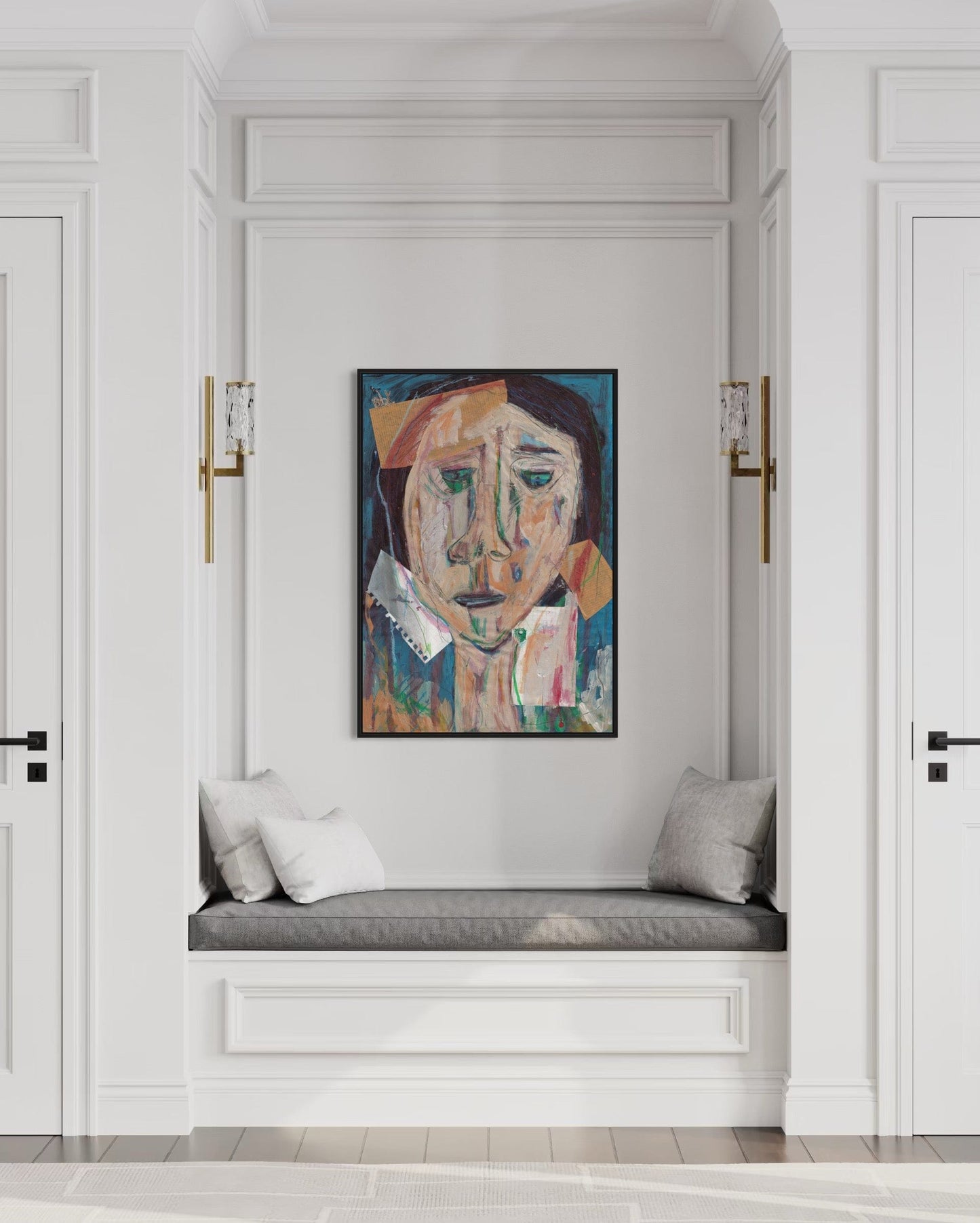 Artistic portrait on a wall above a cushioned bench in a stylish interior.