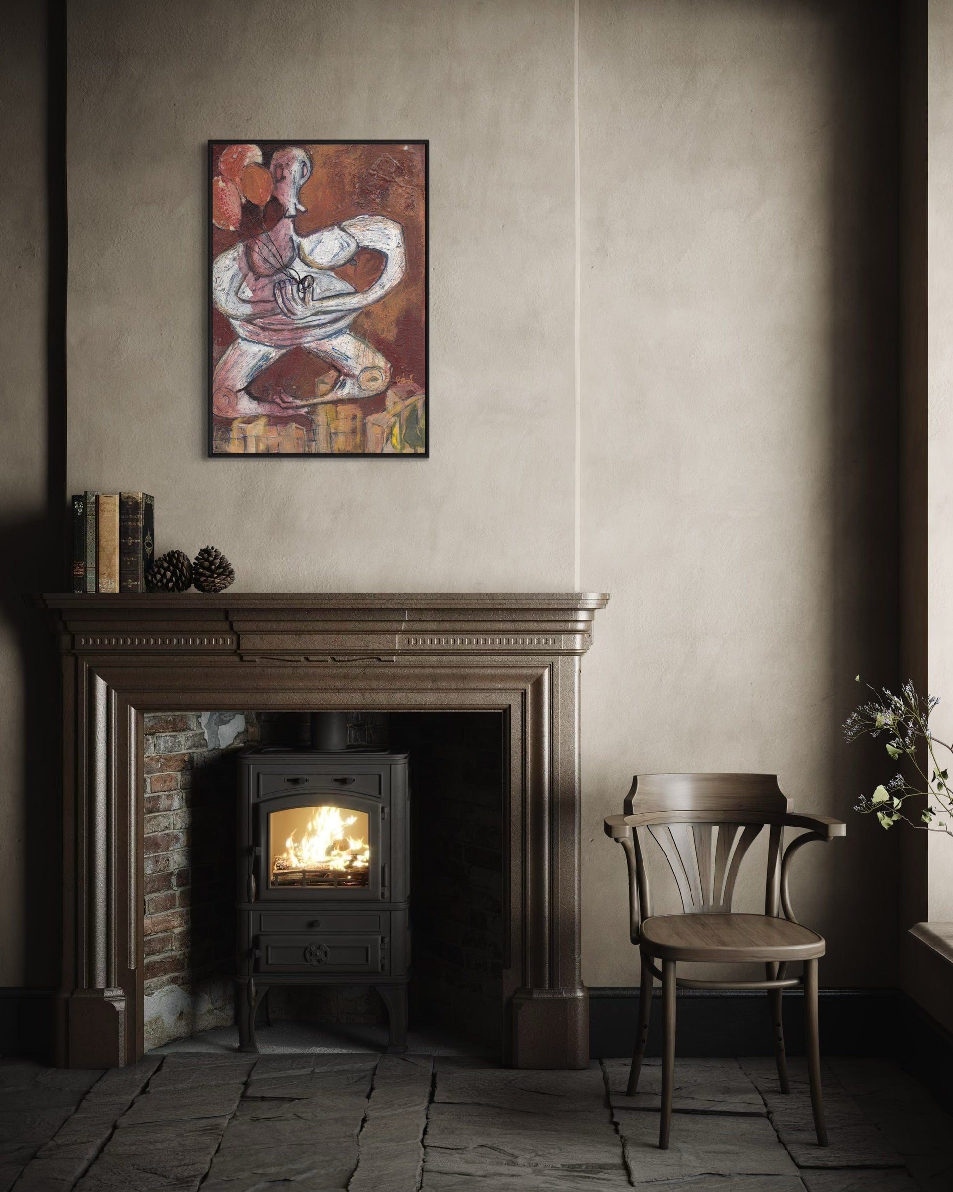 Cozy room with a lit wood stove, chair, and framed artwork on the wall.