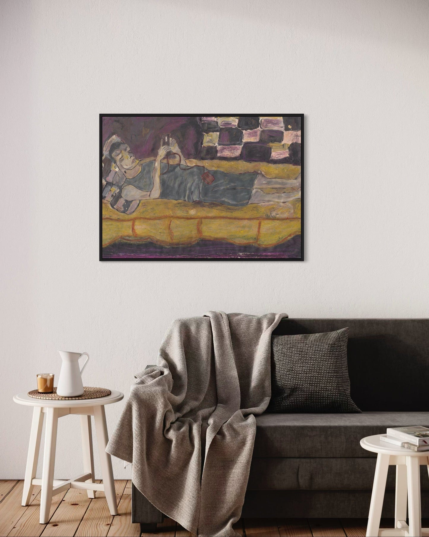 Framed painting on a wall above a sofa in a living room