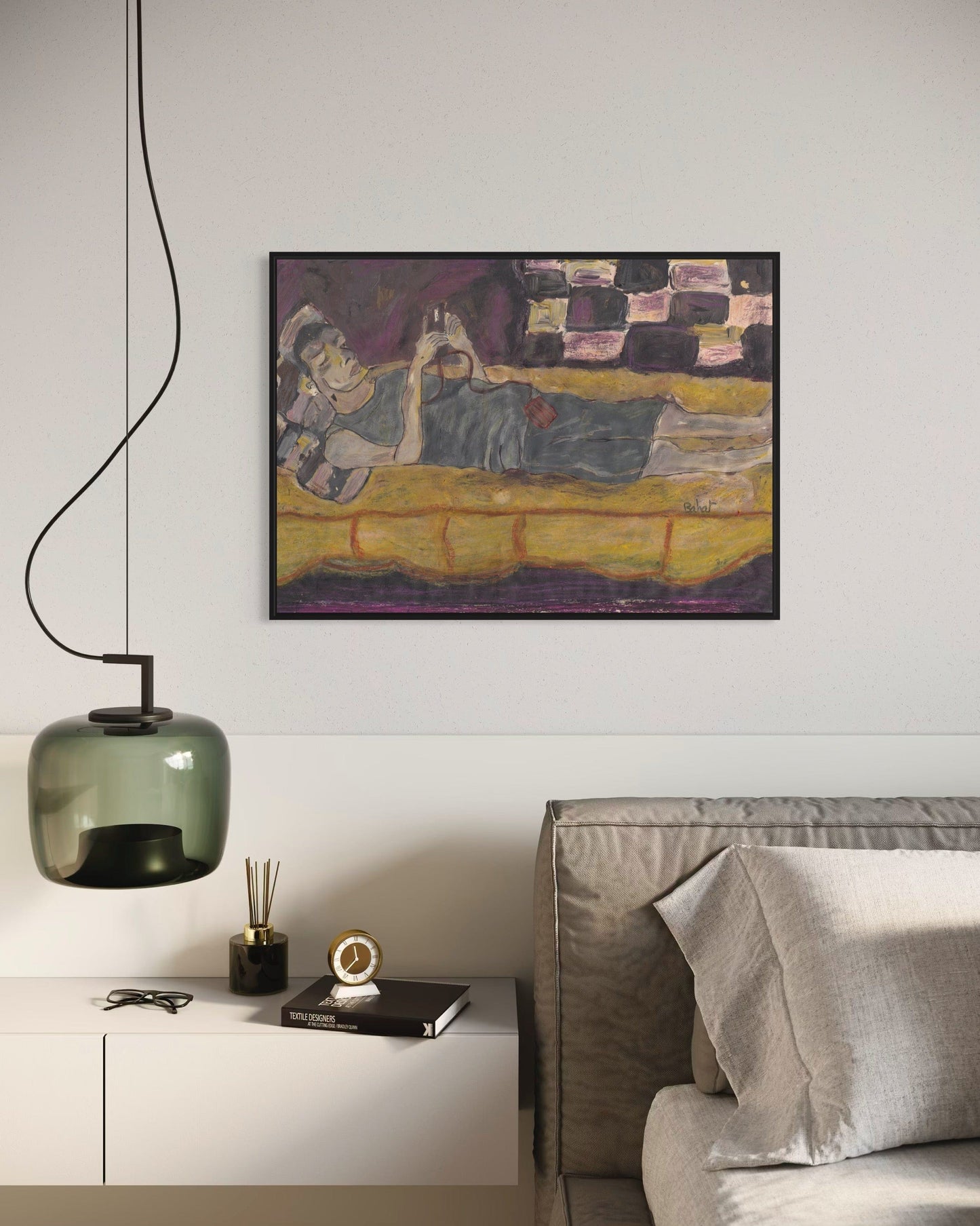Modern living room with a painting on the wall, a sofa, and decorative items.