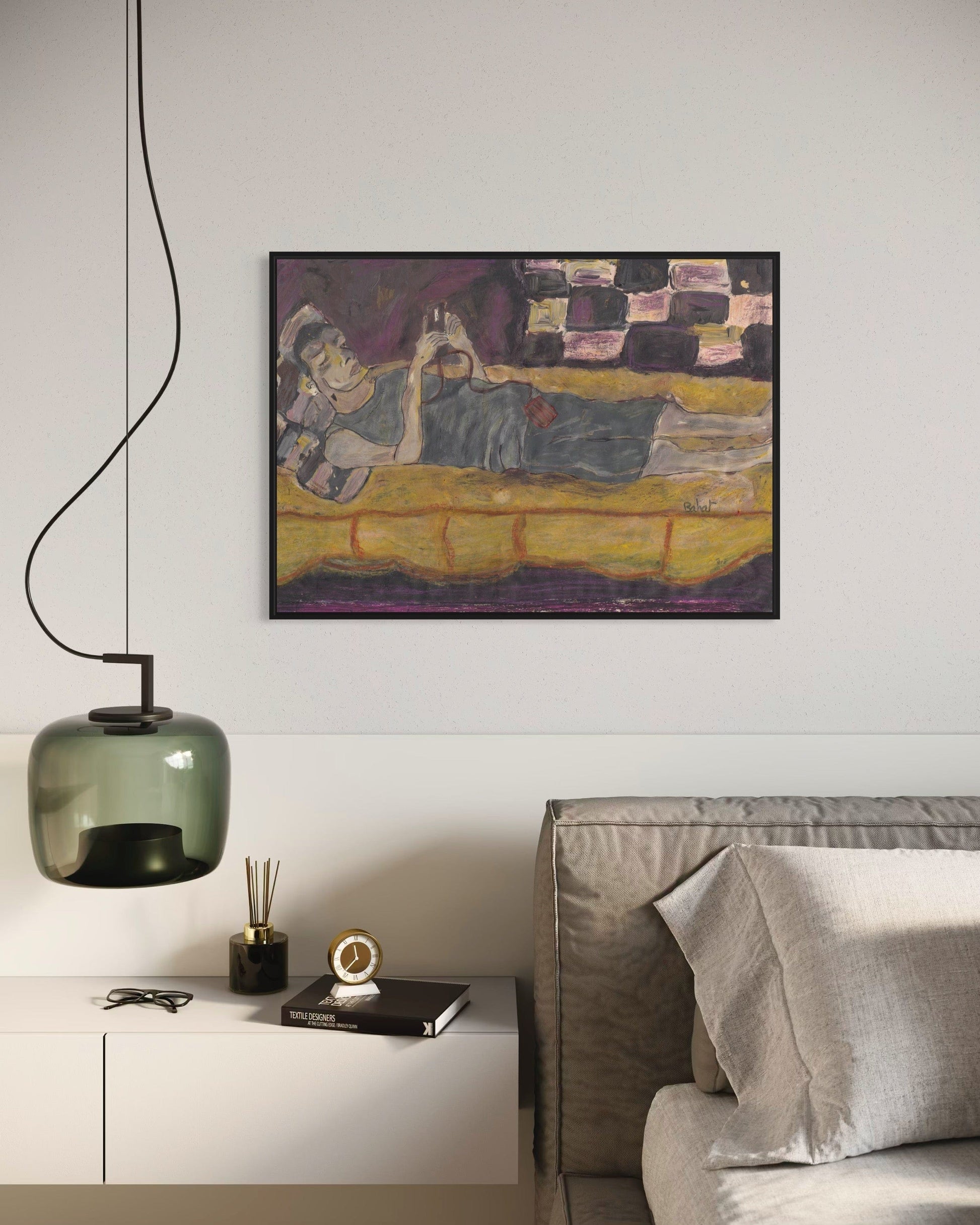 Modern living room with a painting on the wall, a sofa, and decorative items.