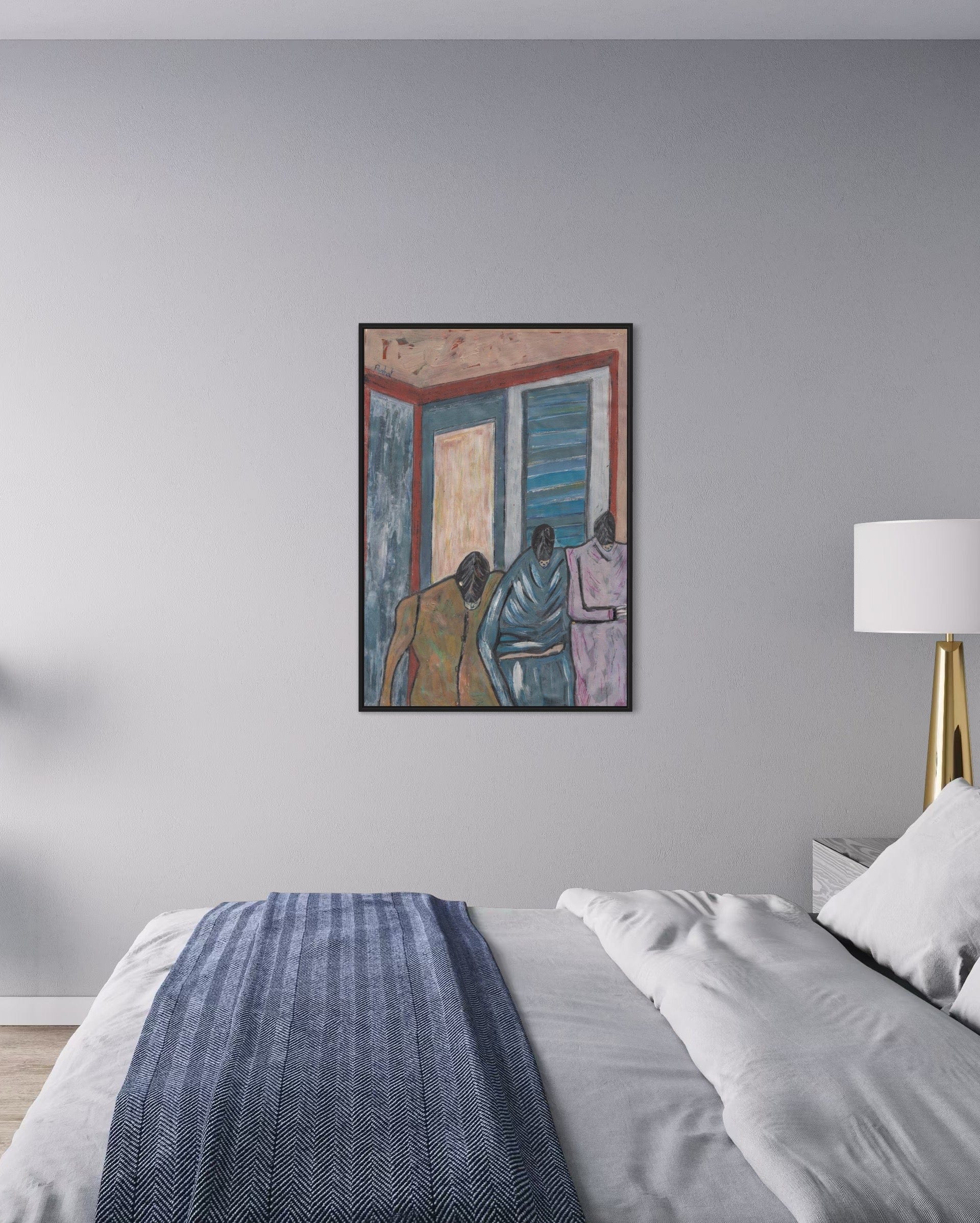 Framed artwork above a bed with a lamp on a nightstand.
