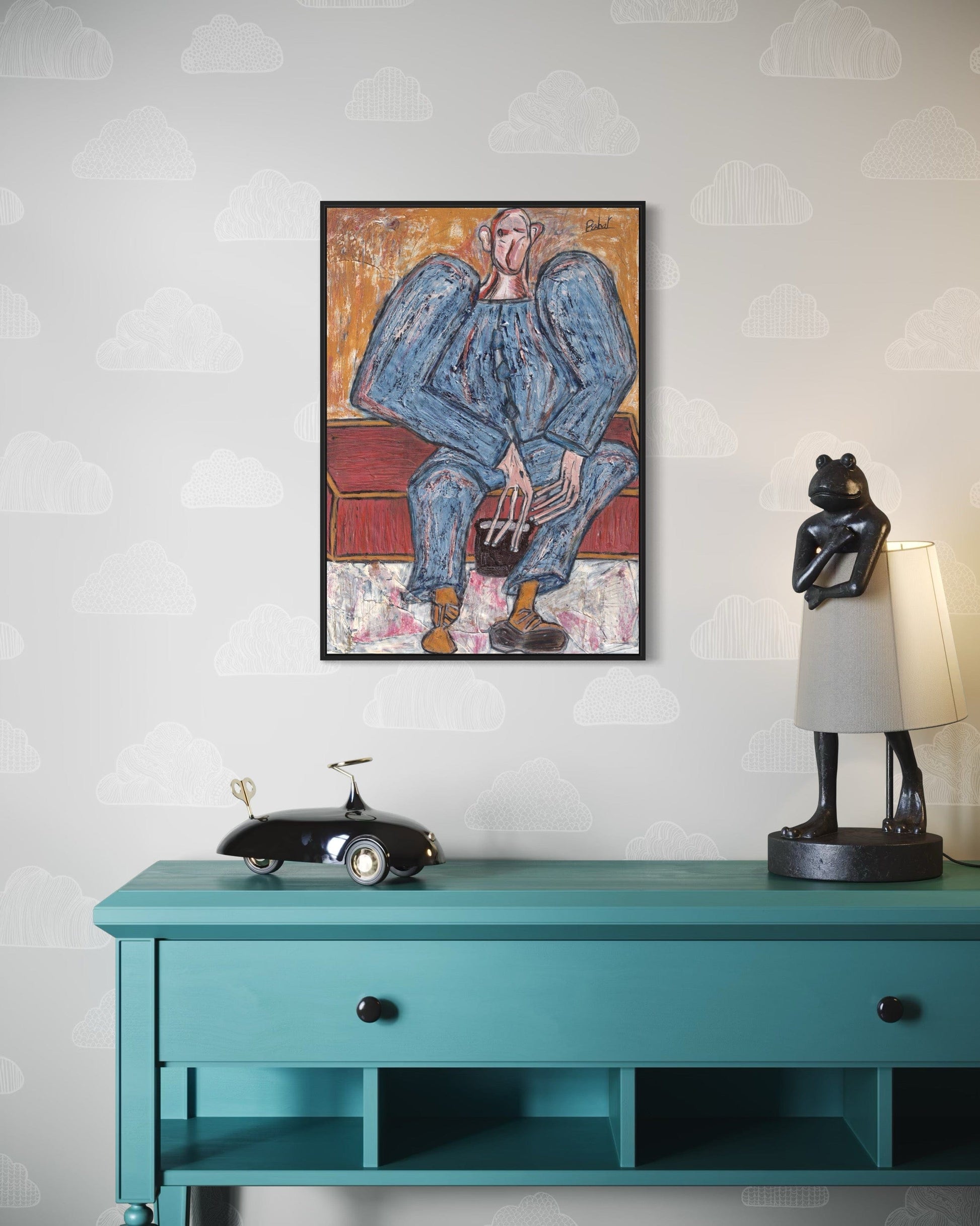 Framed artwork above a teal console table with decorative items.