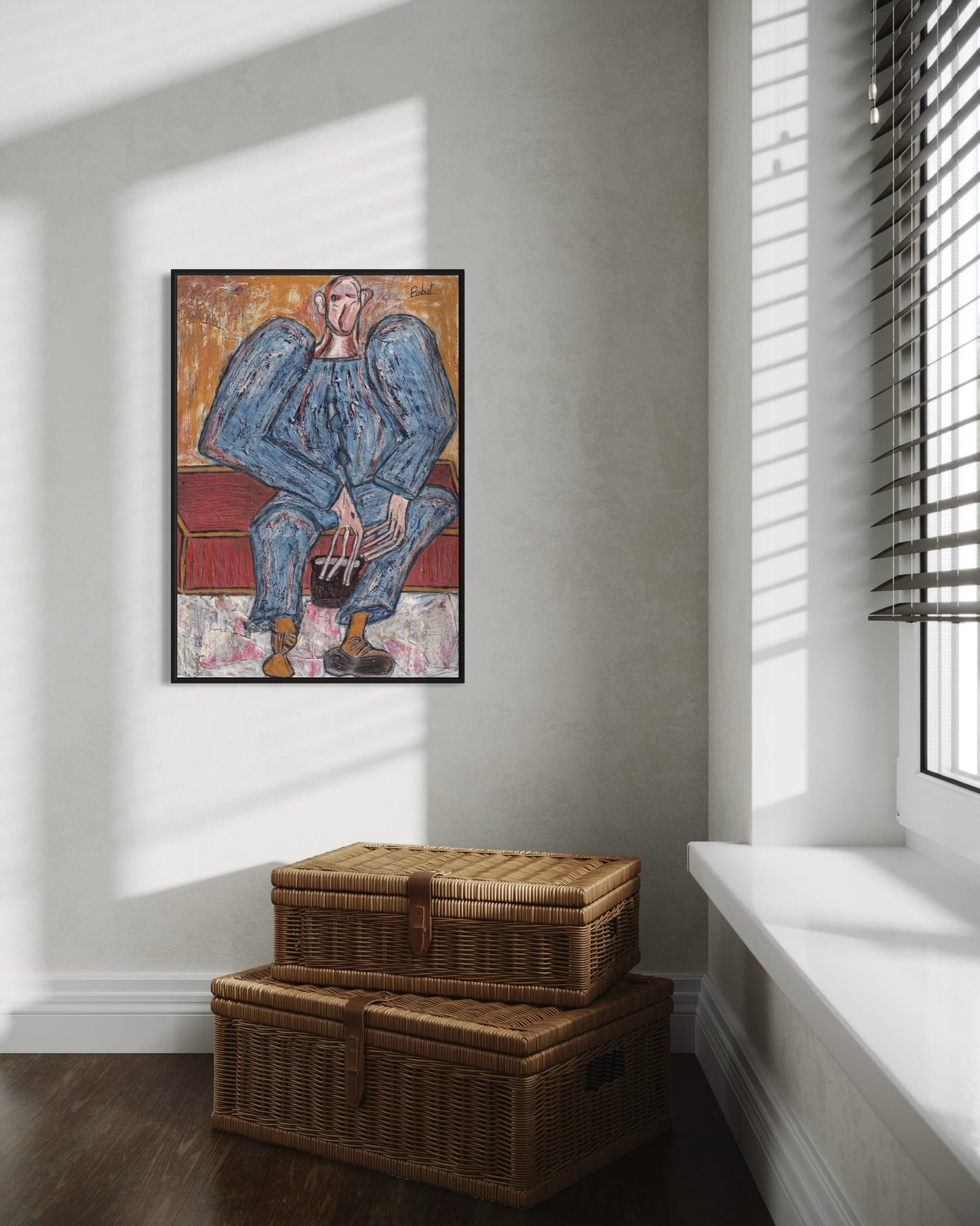 Framed artwork of a blue figure on a wall above two wicker baskets.