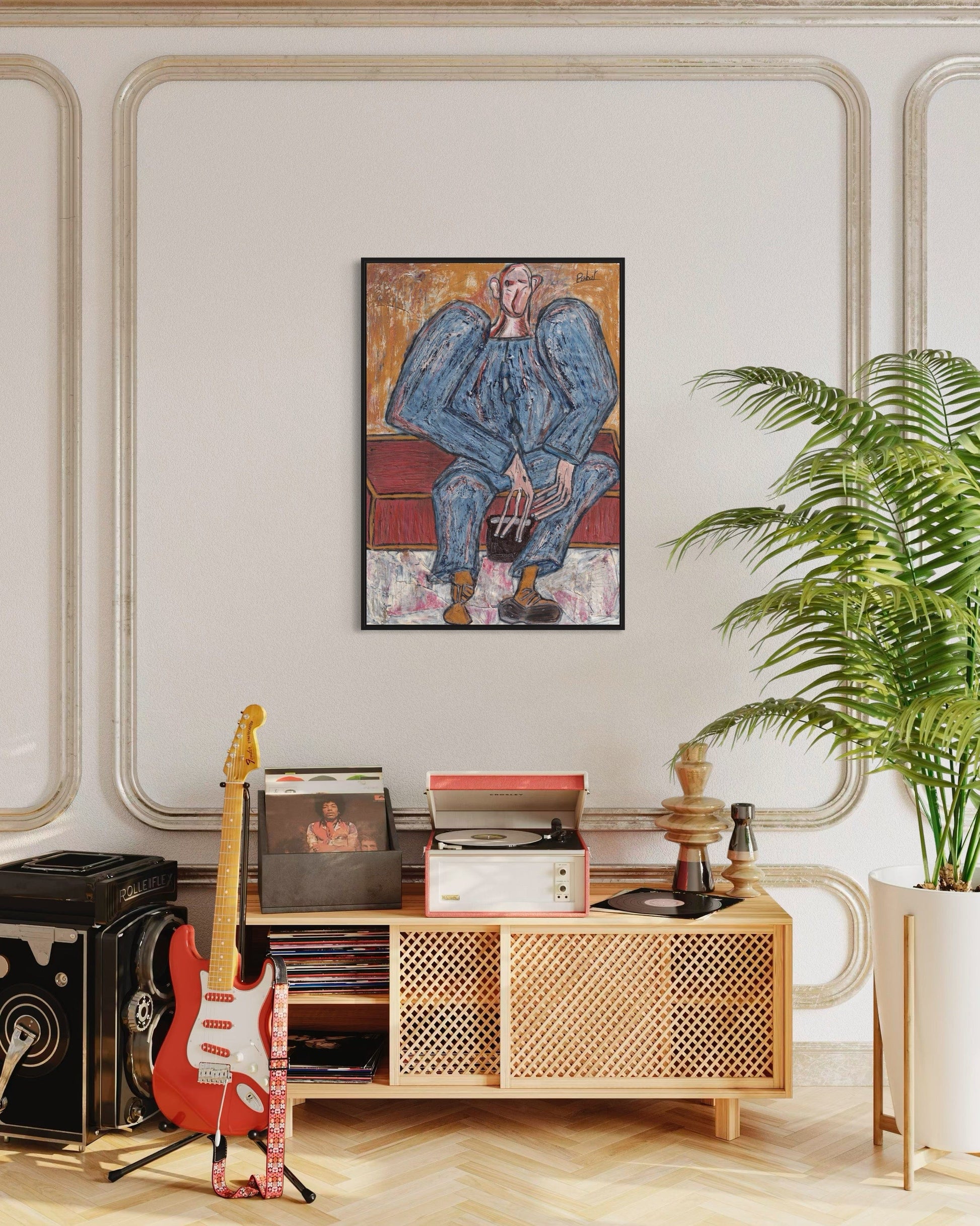 Living room with a wooden cabinet, guitar, and framed artwork on a wall.