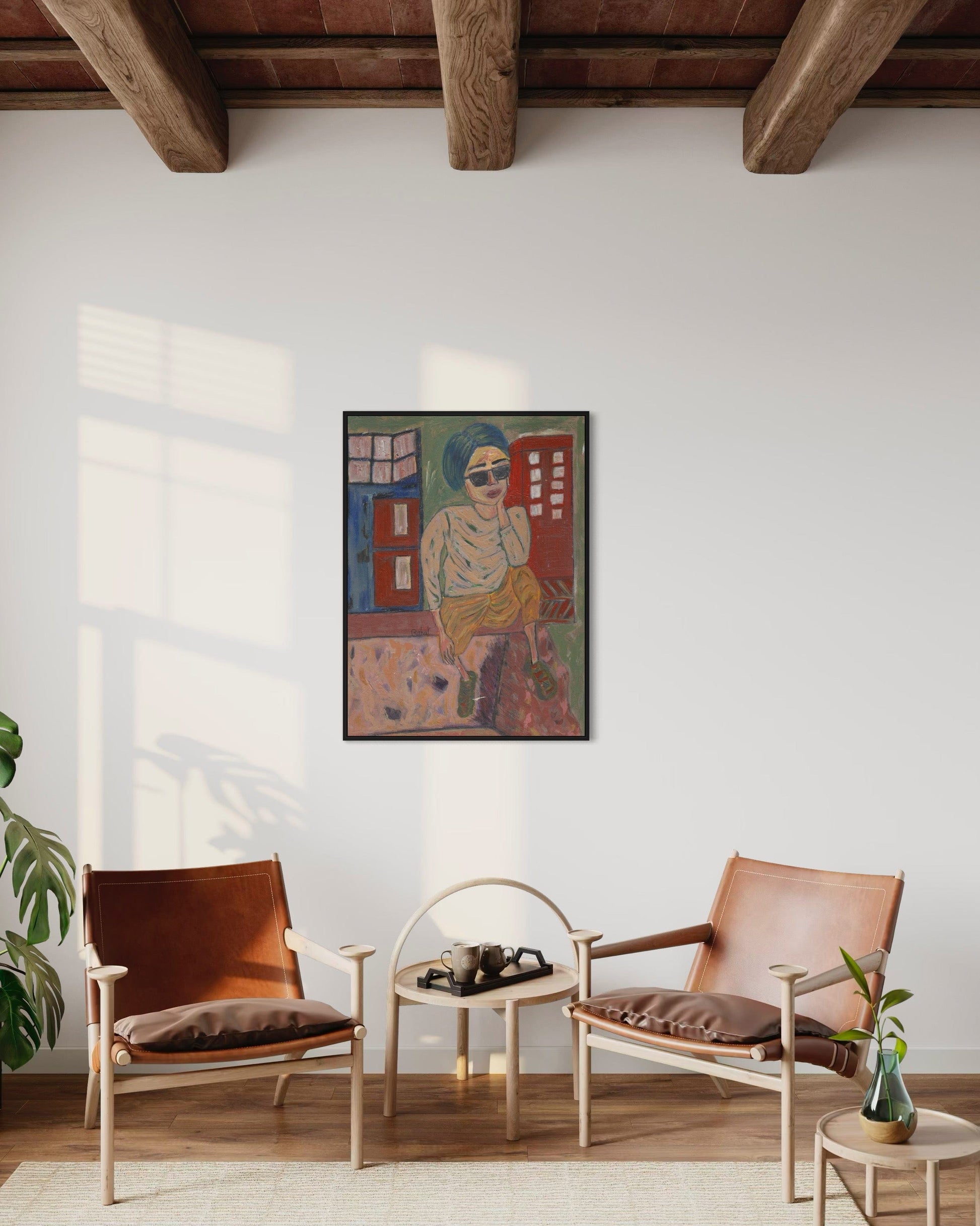 Living room with two brown chairs, a small table, and a colorful painting on the wall.