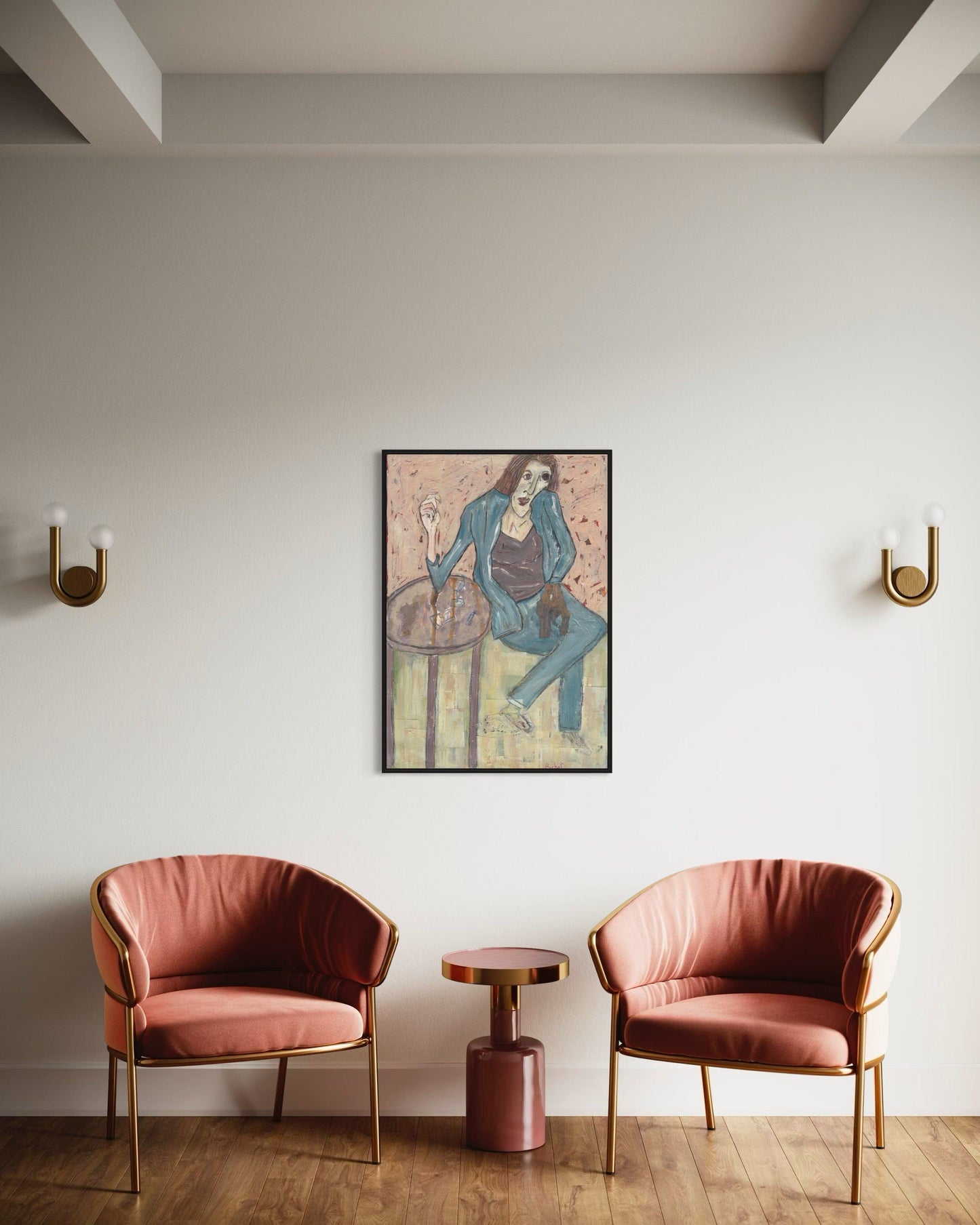Two pink chairs with a small round table and a framed picture on a white wall.