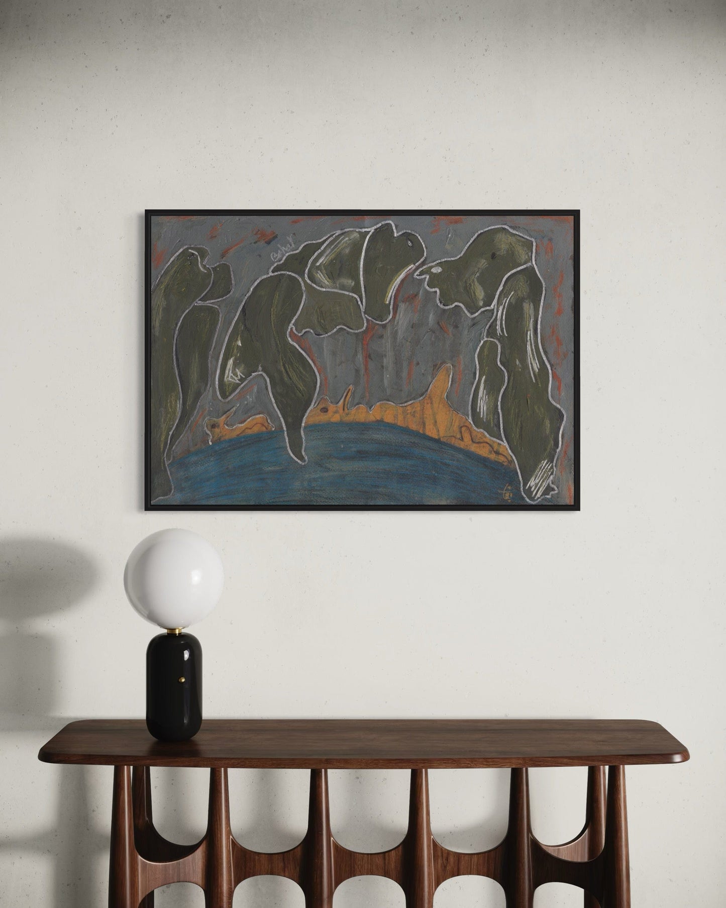 Framed abstract painting above a wooden console table with a lamp.