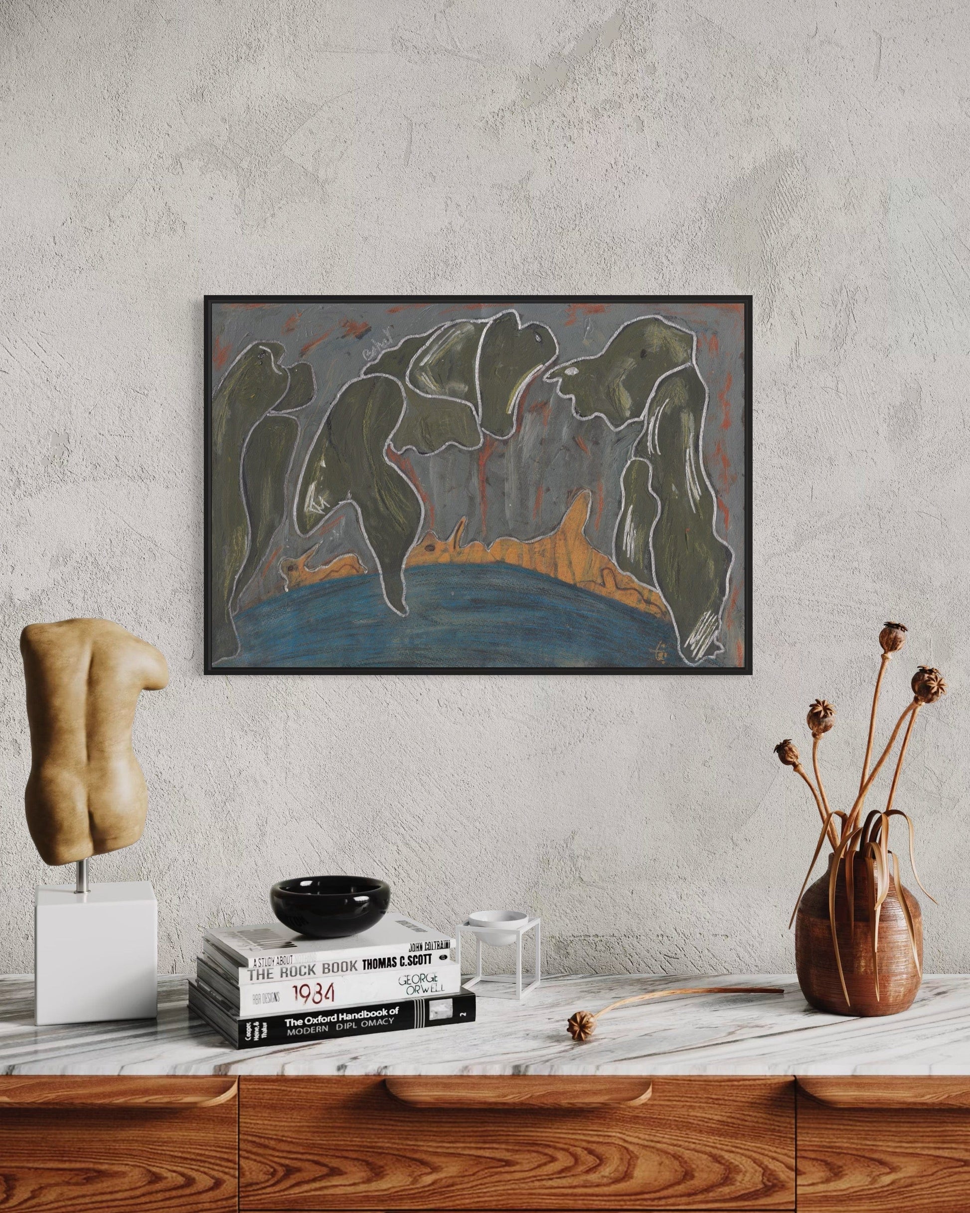 Framed abstract painting on a wall above a wooden shelf with decorative items.