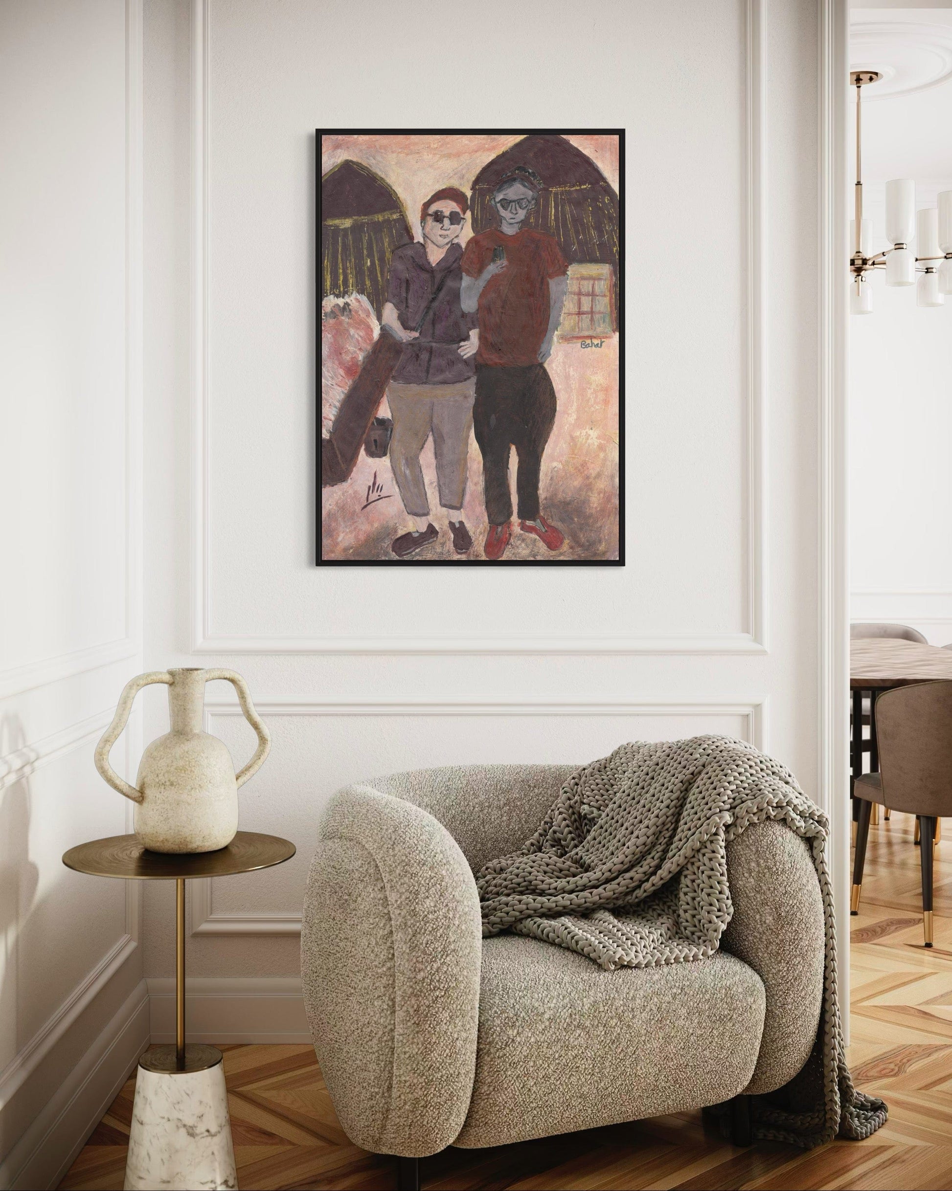 Cozy living room with a textured armchair, side table, and wall art.