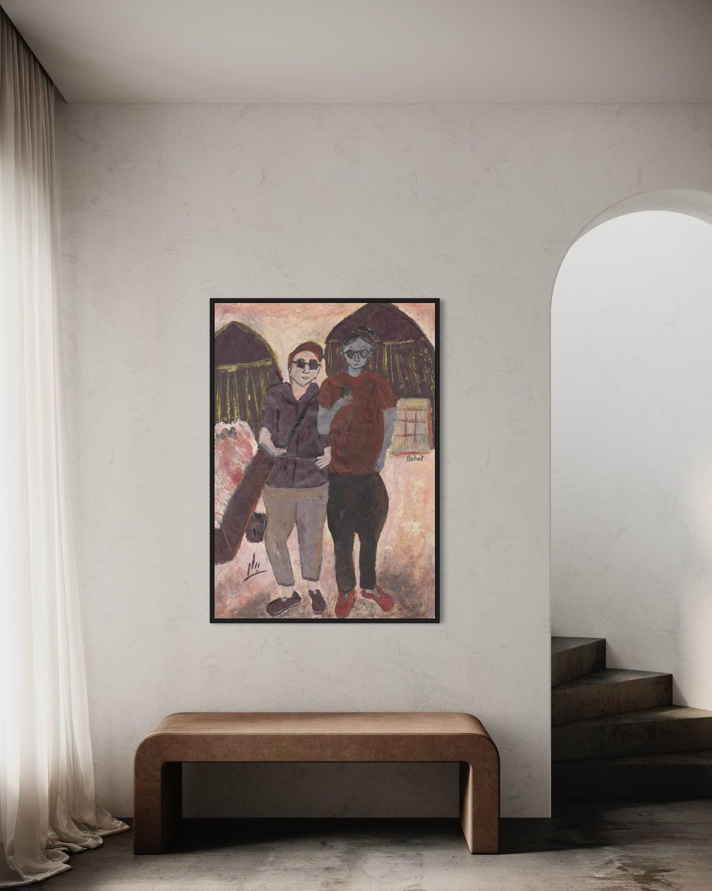 Framed artwork of two people on a wall in a room with a wooden bench and white curtains.