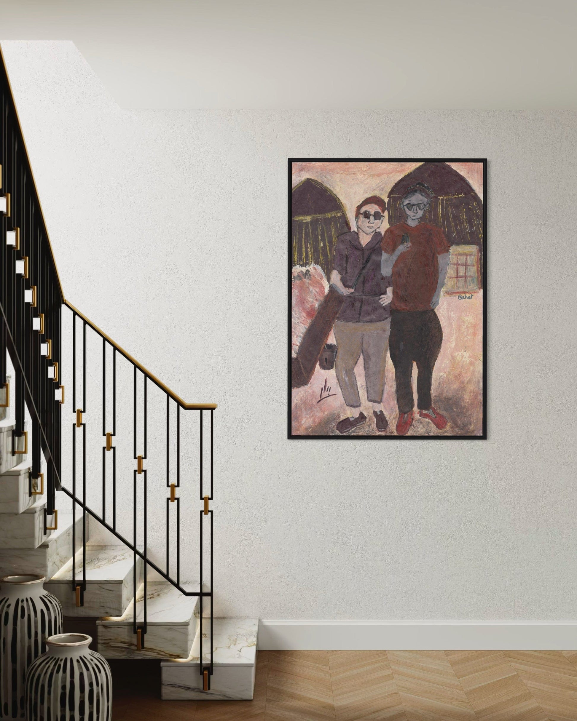 Framed artwork of three people hugging on a wall above a staircase.