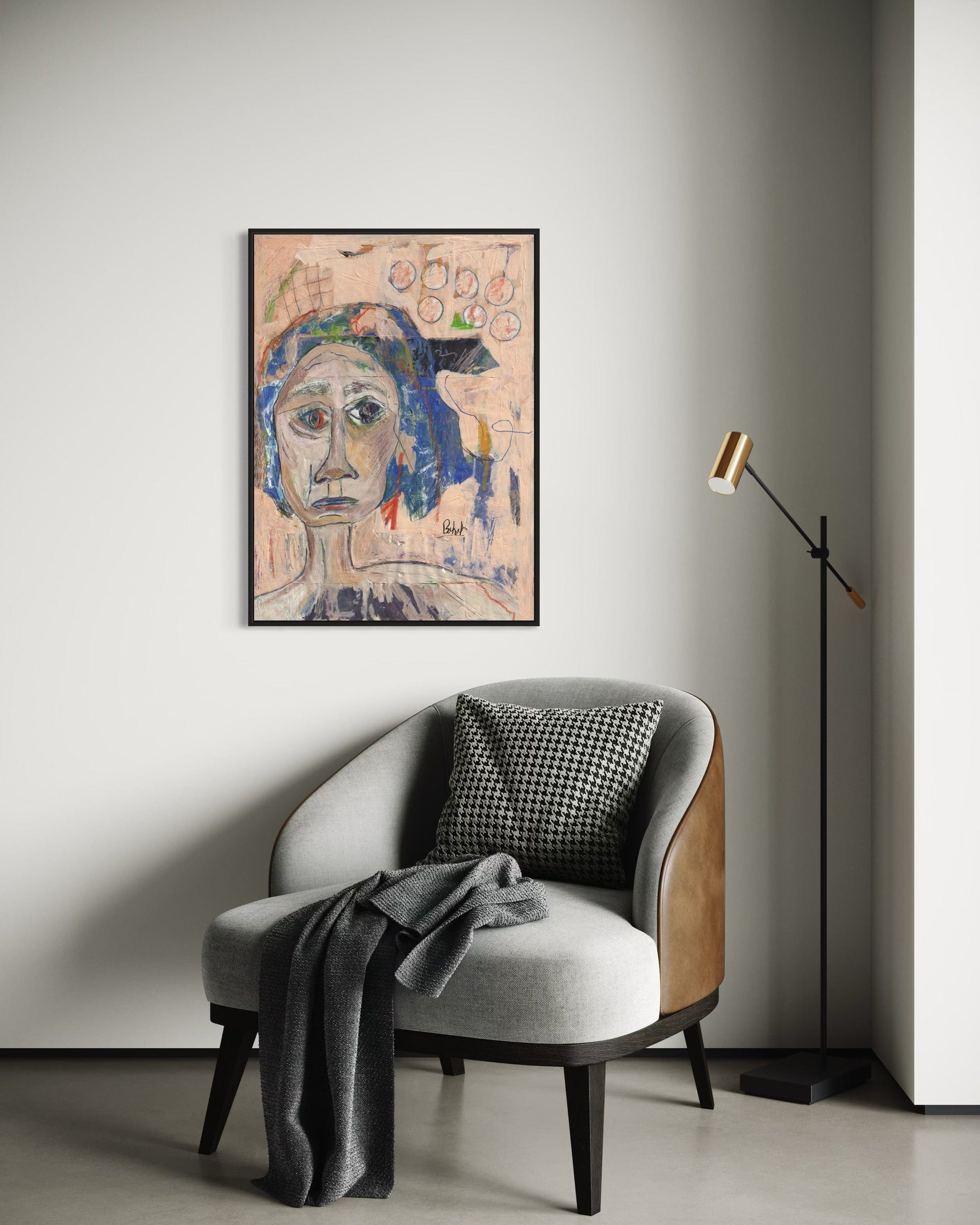 Modern interior with a chair, lamp, and framed artwork on the wall.