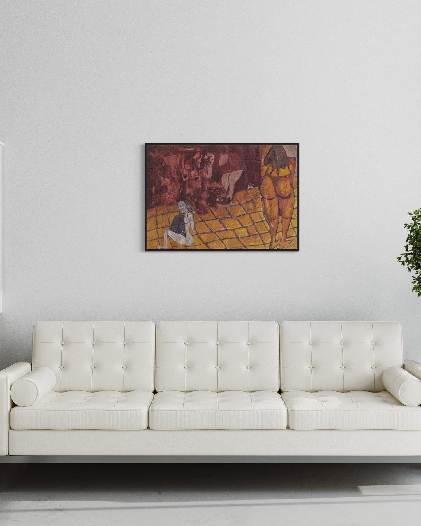 White sofa in a room with a framed artwork on the wall.