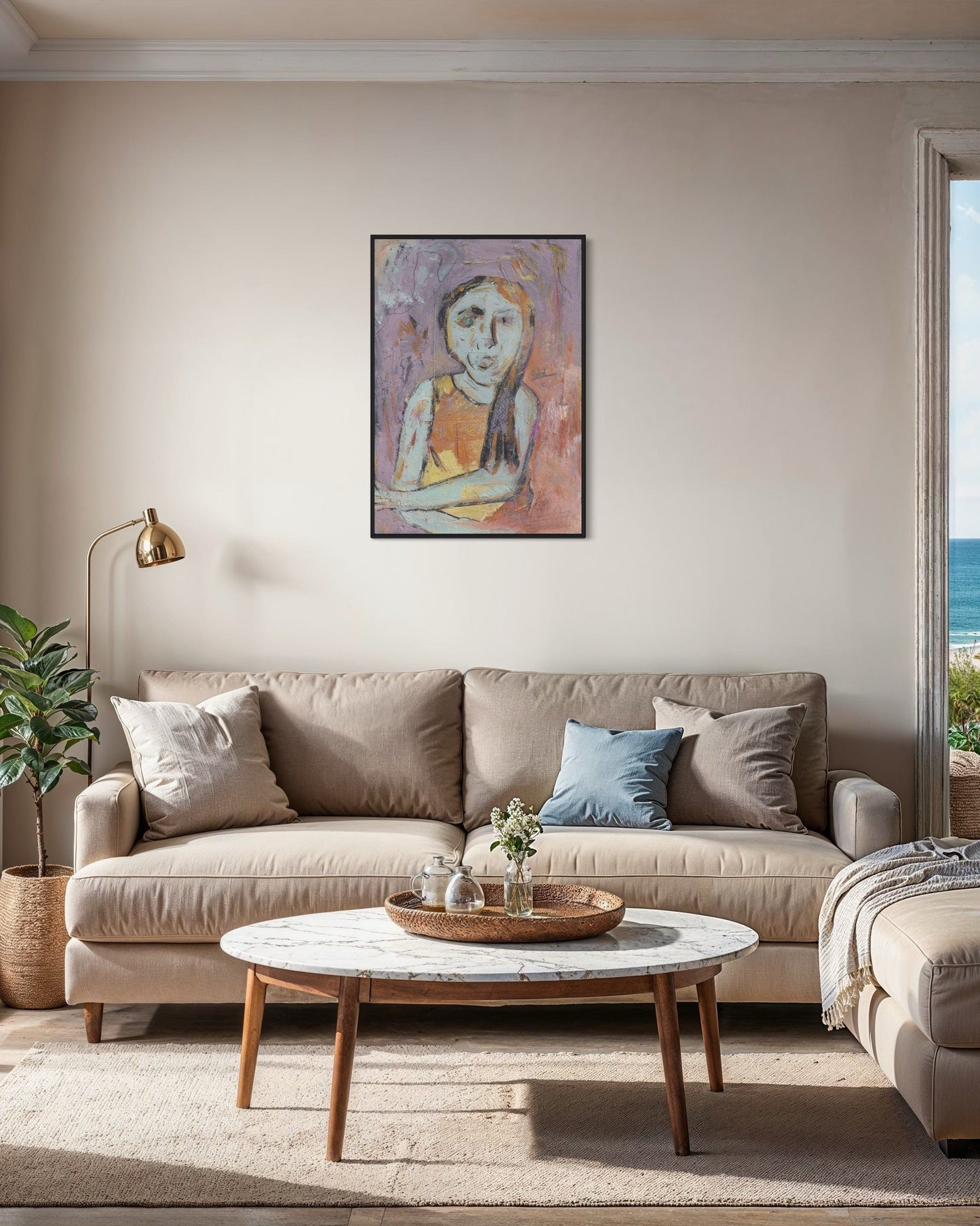 Living room with beige sofa, round coffee table, and wall art