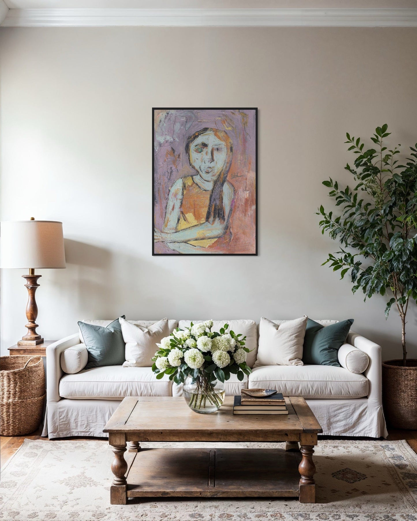 Living room with a white sofa, wooden coffee table, and wall art.