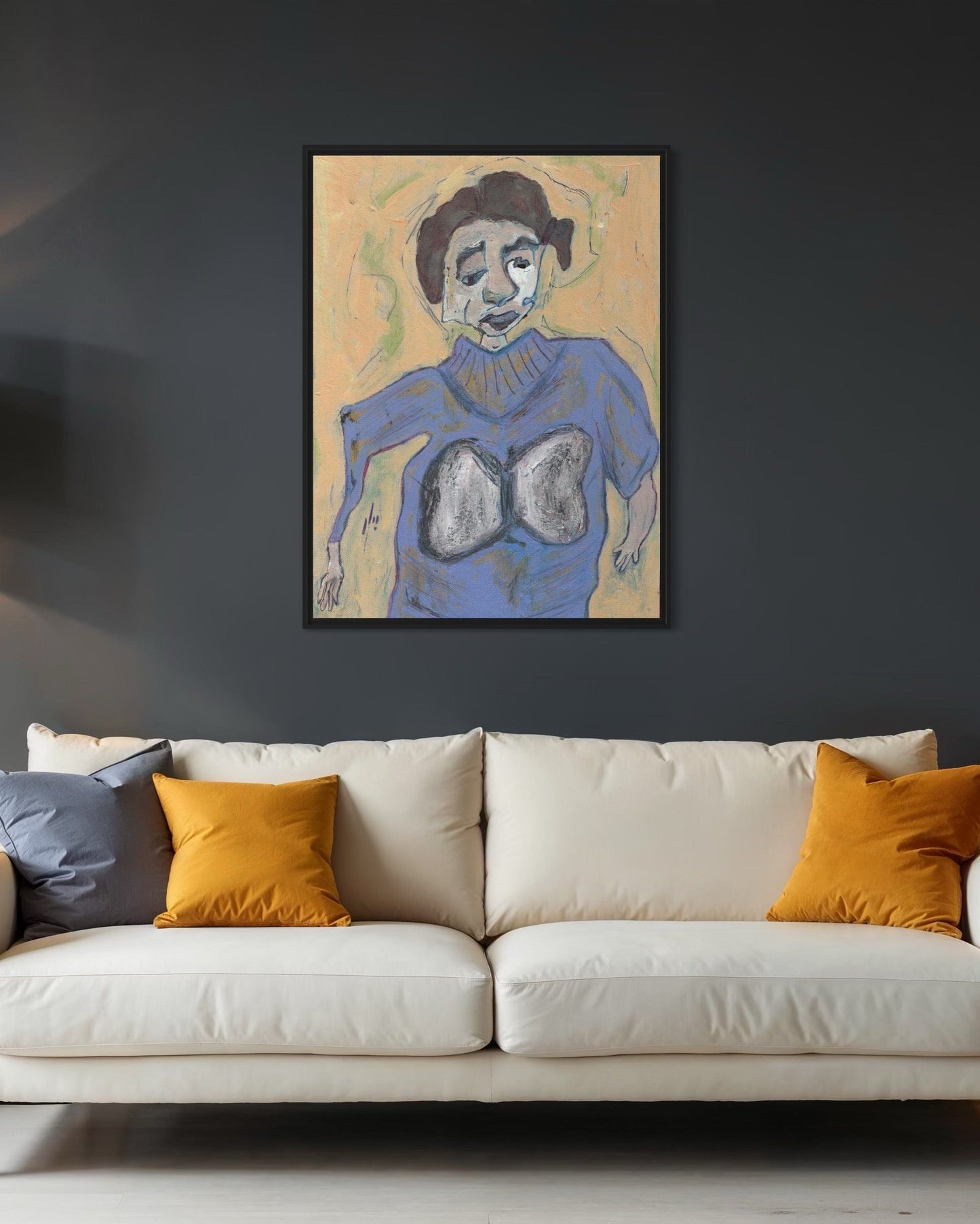 Framed artwork of a stylized figure on a dark wall above a white sofa with colorful cushions.