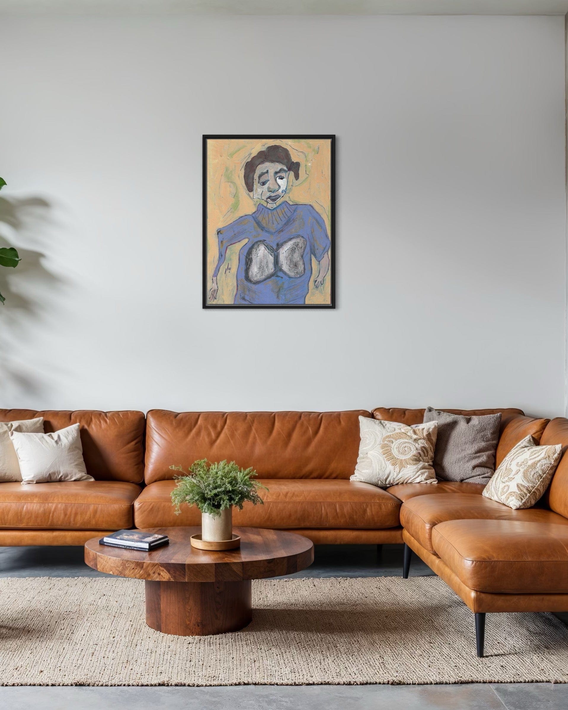 Living room with brown leather sectional sofa, wooden coffee table, and framed artwork on the wall.