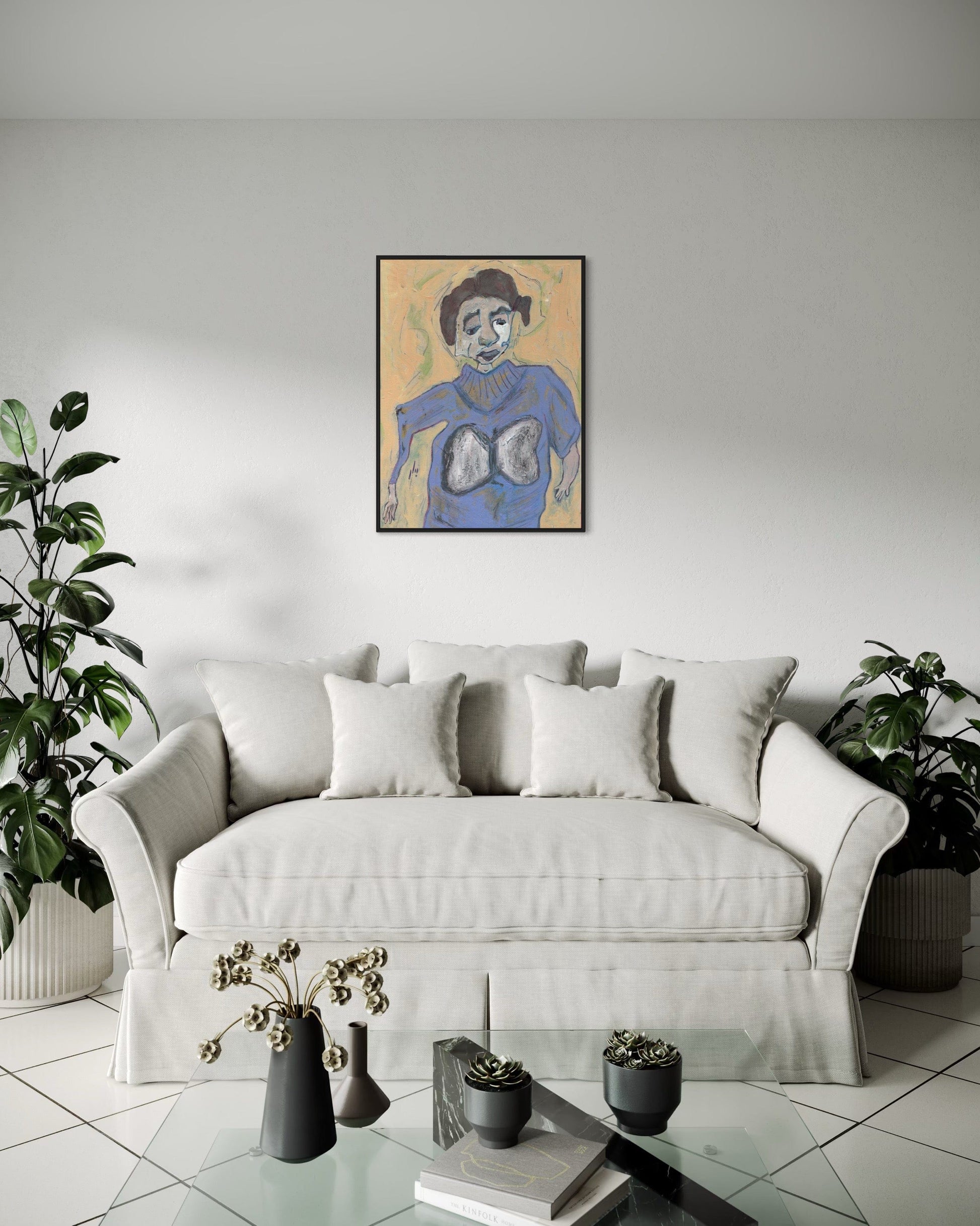 Living room with a white sofa, decorative pillows, and a framed artwork on the wall.