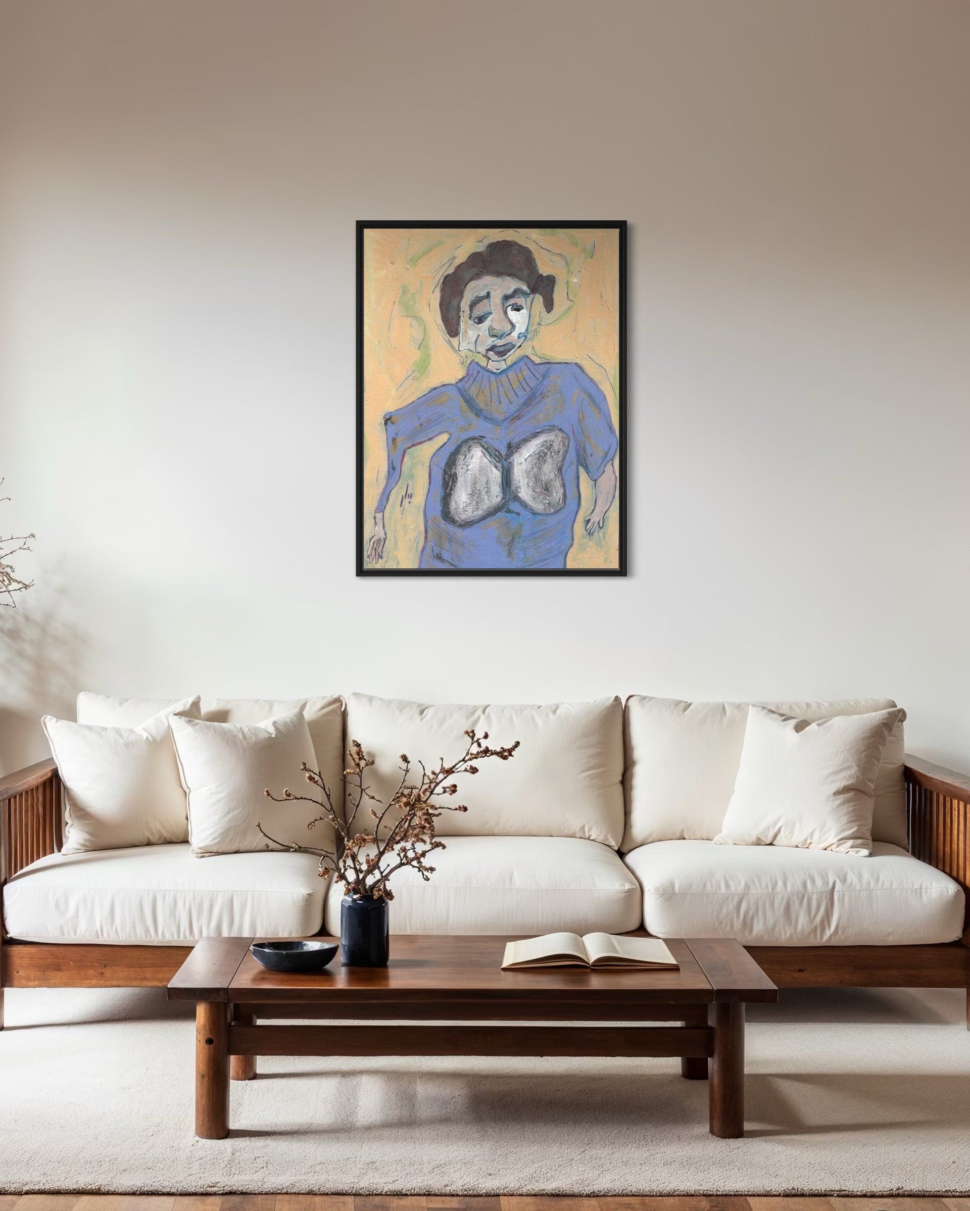 Framed artwork above a white sofa in a living room