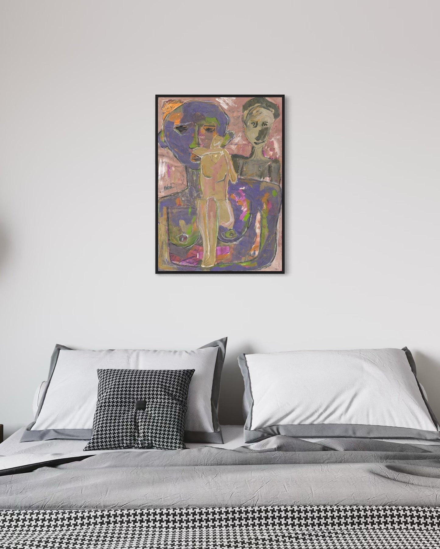 Framed abstract artwork above a bed with pillows and a blanket.