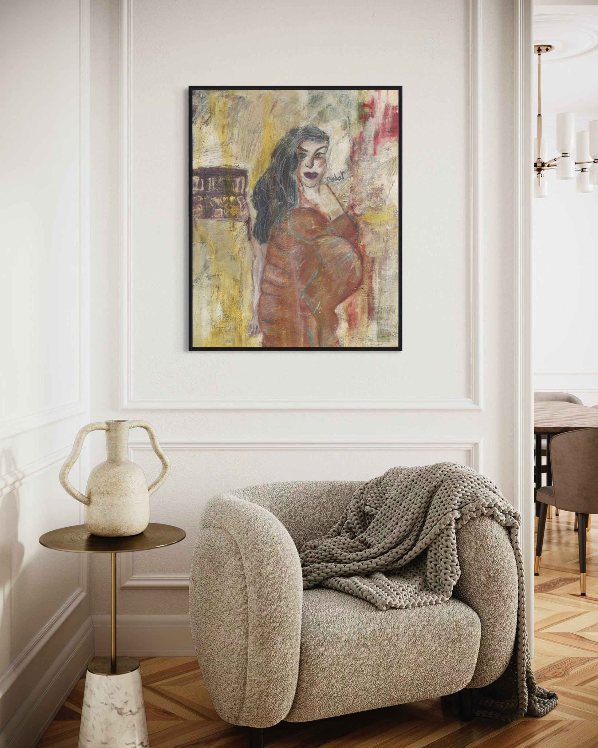 Living room with a textured armchair, side table, and wall art