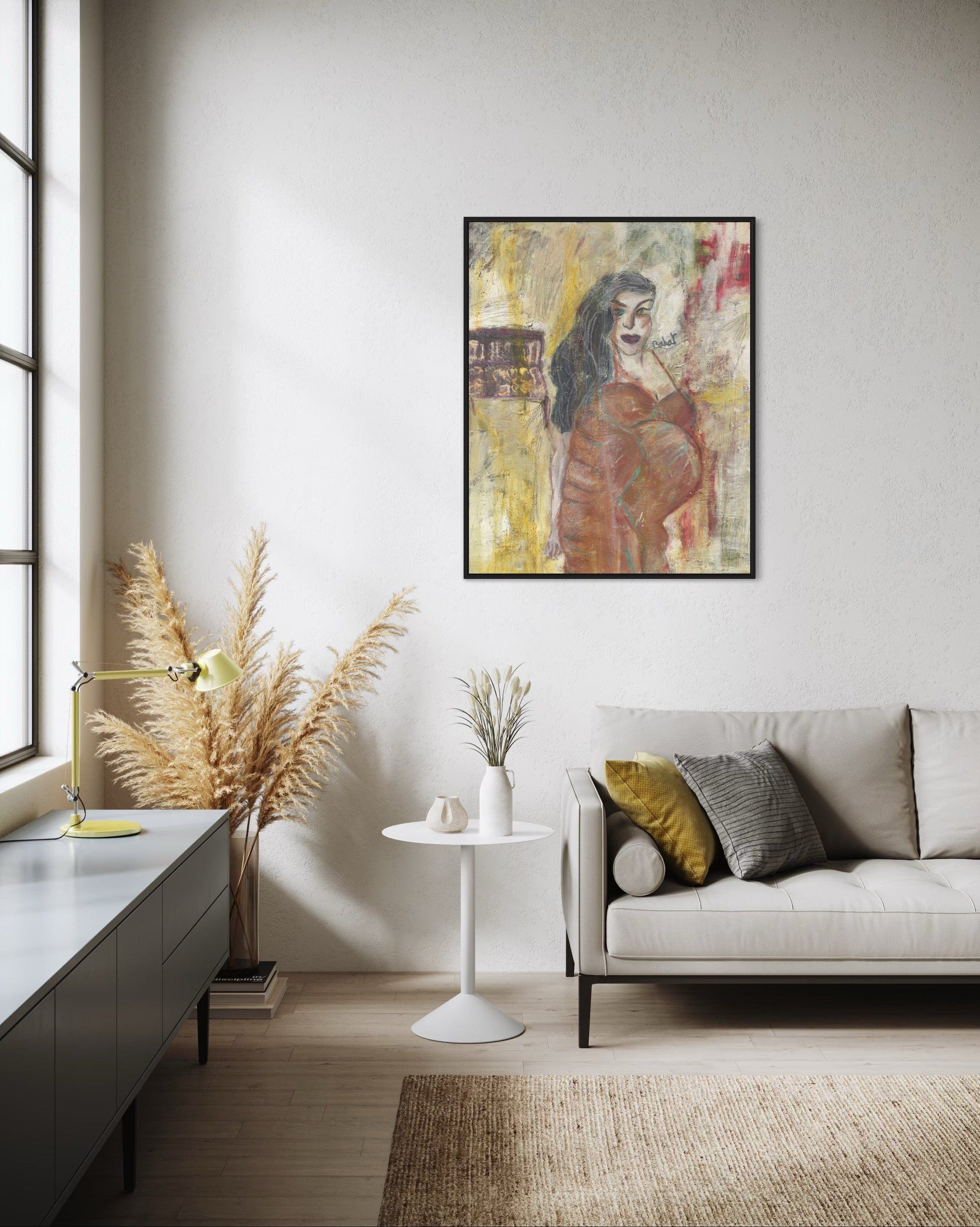 Modern living room with a framed artwork on the wall, a sofa, and decorative elements.