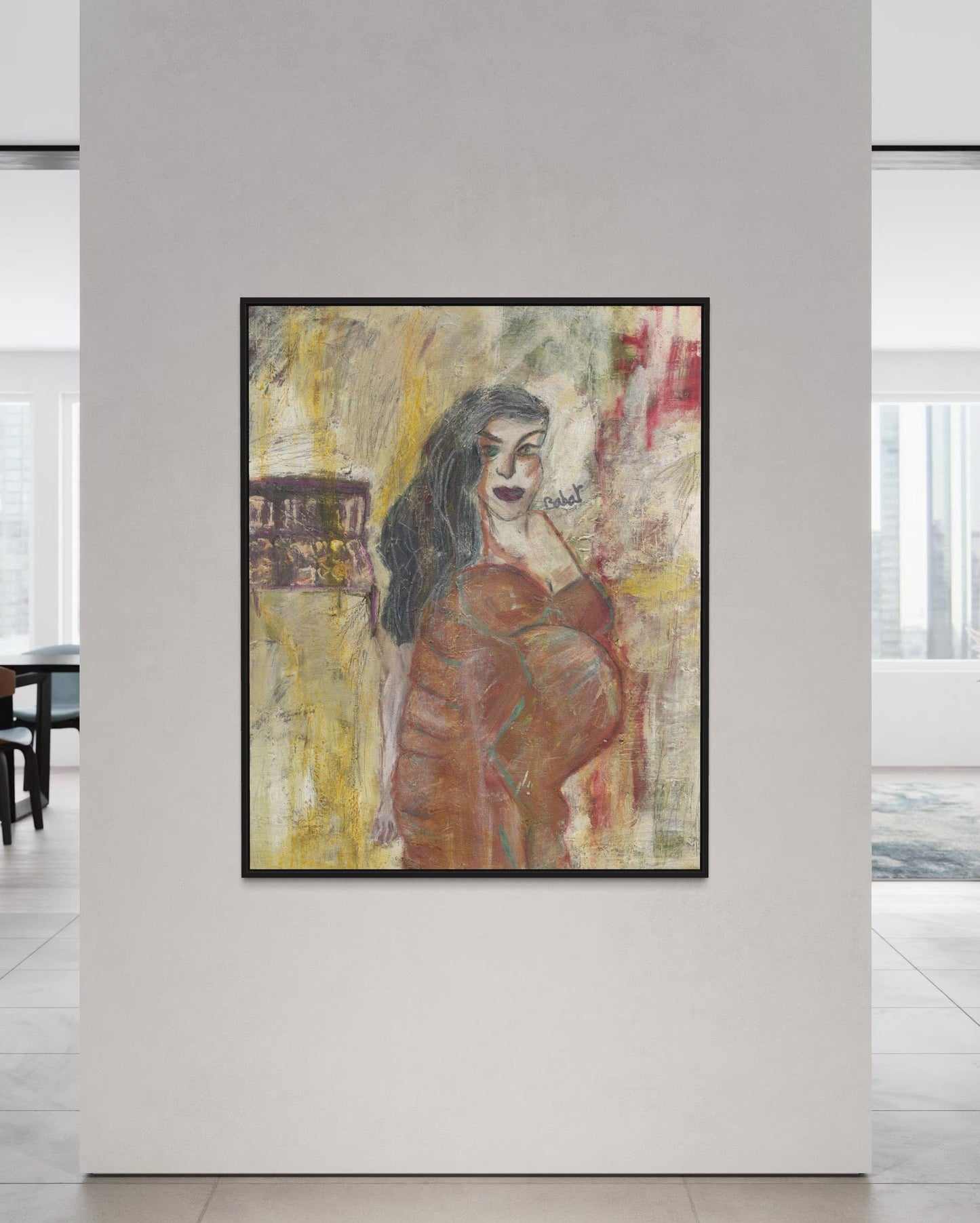 Framed abstract painting of a woman on a white wall