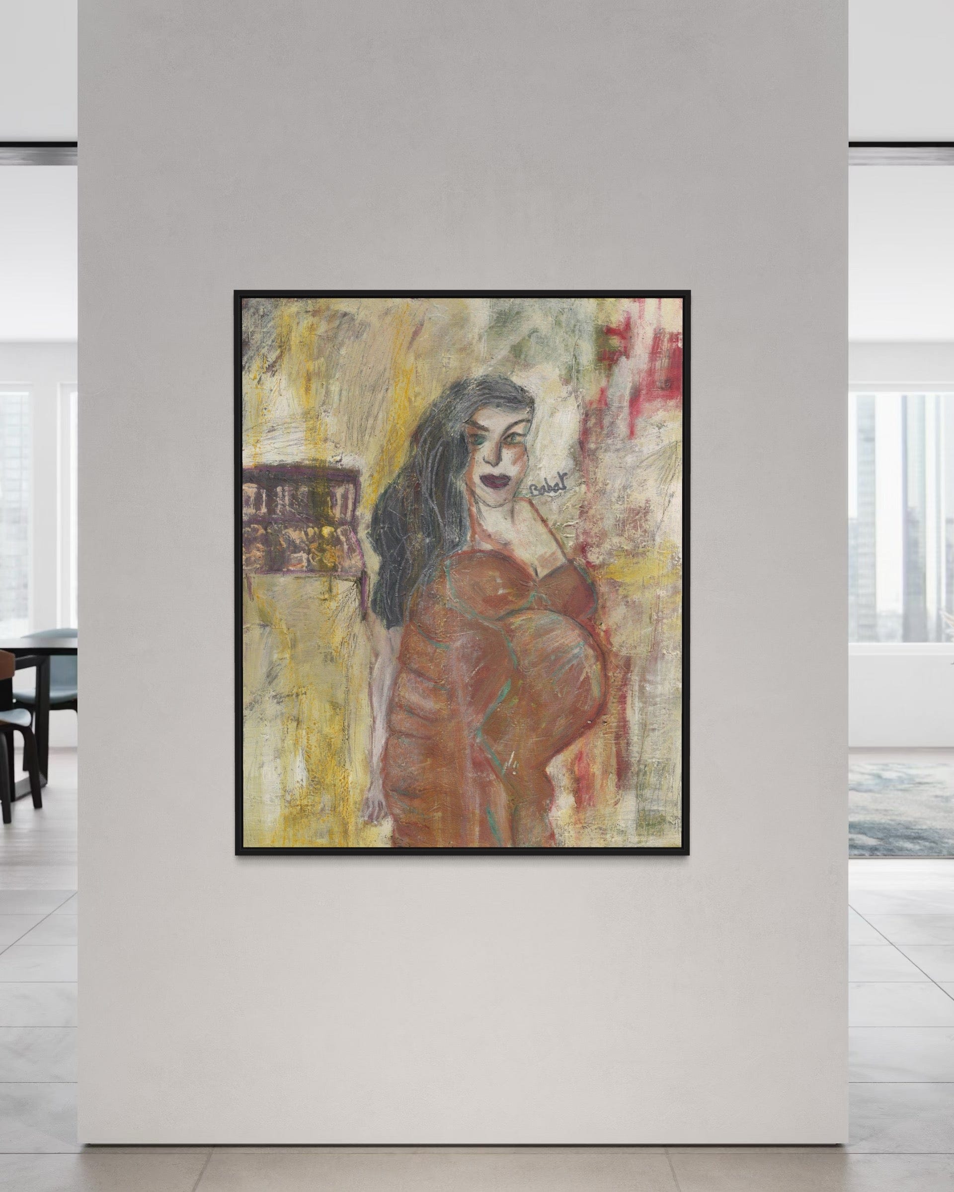 Framed abstract painting of a woman on a white wall