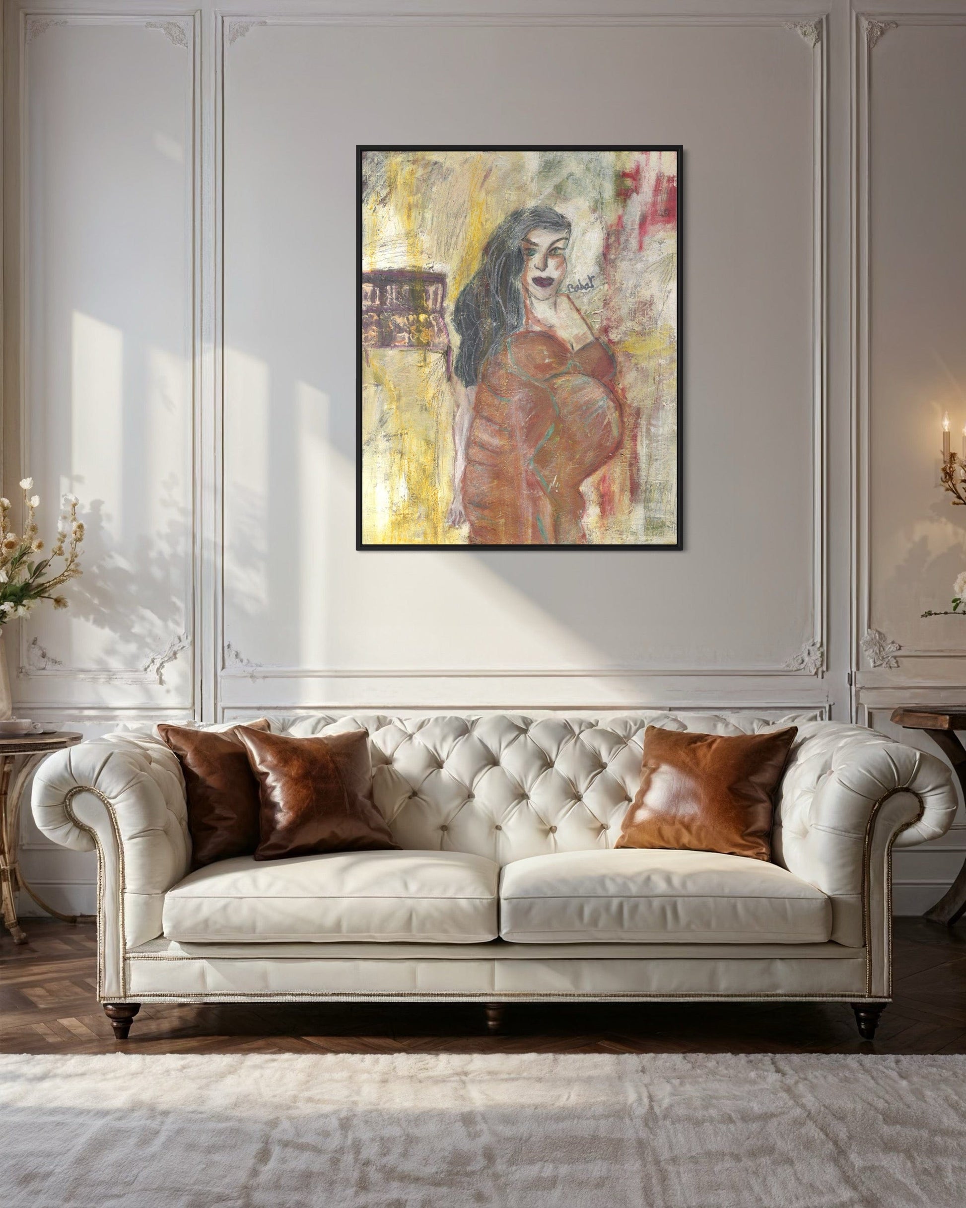 White tufted sofa with brown cushions in a room with a large abstract painting on the wall.