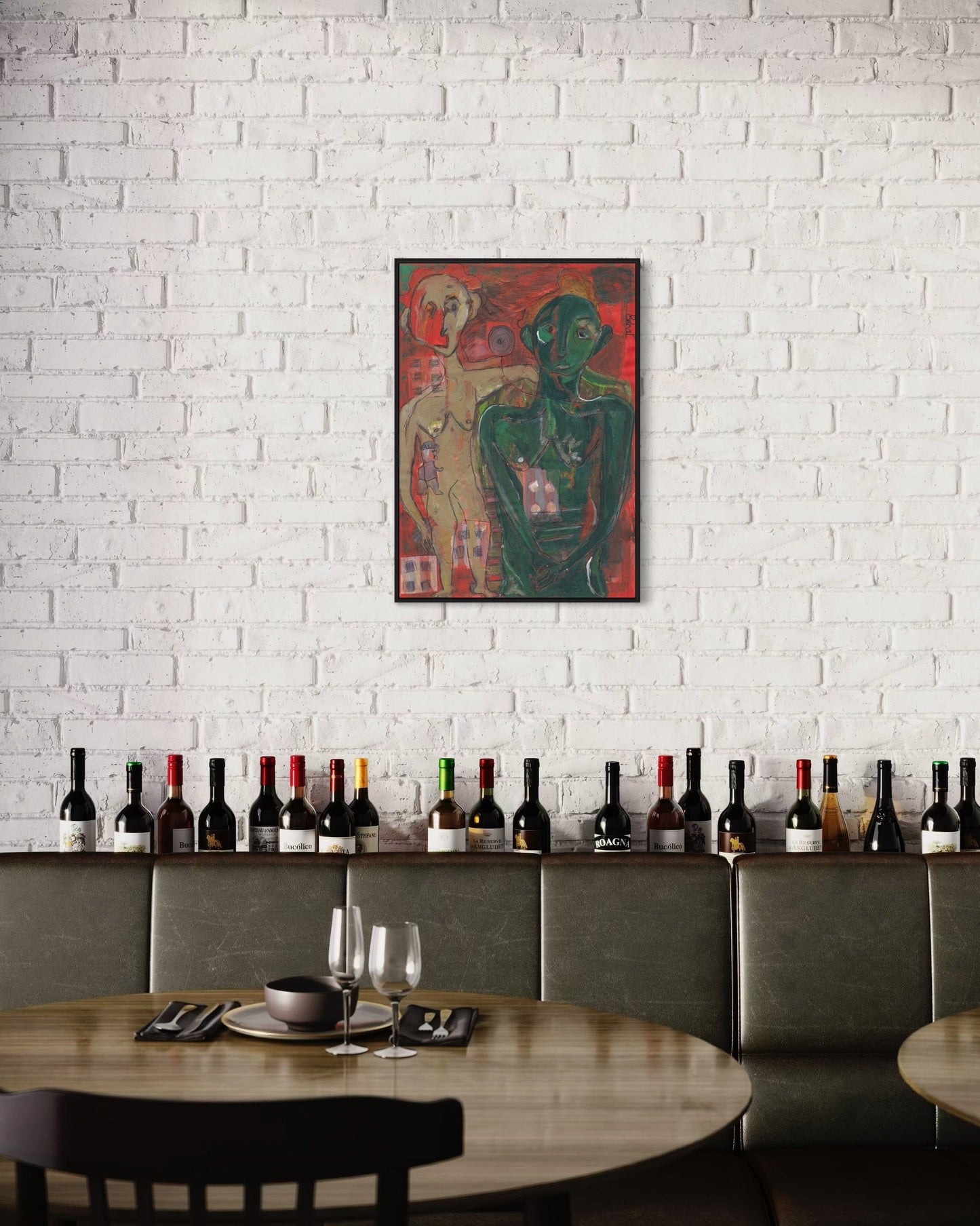 Dining area with a painting of two figures on a white brick wall, wine bottles on a shelf, and a table set with cutlery.