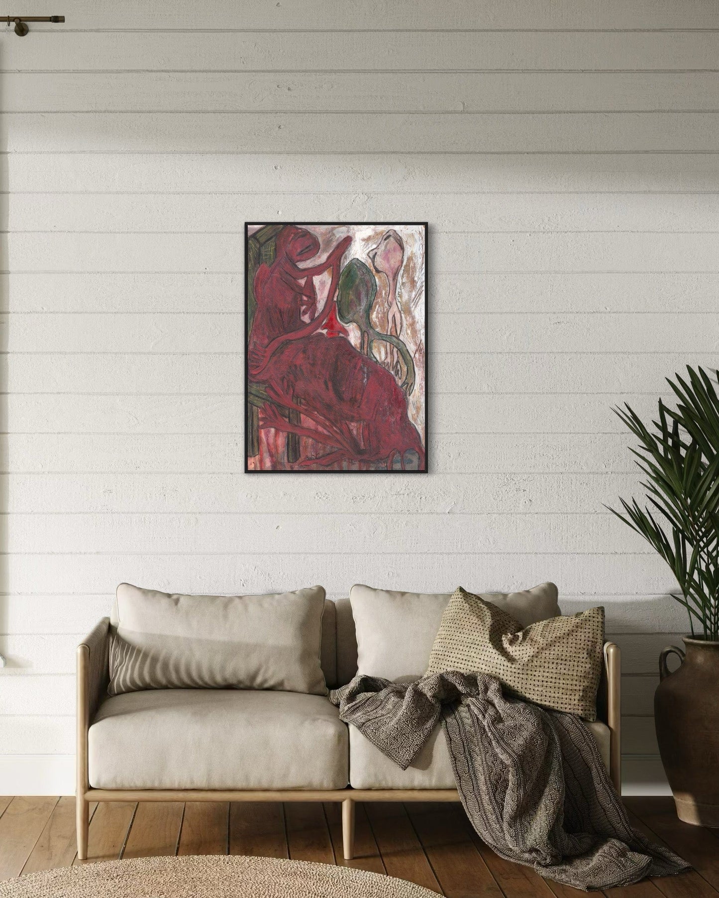 Living room with a beige sofa, abstract painting on the wall, and a plant.