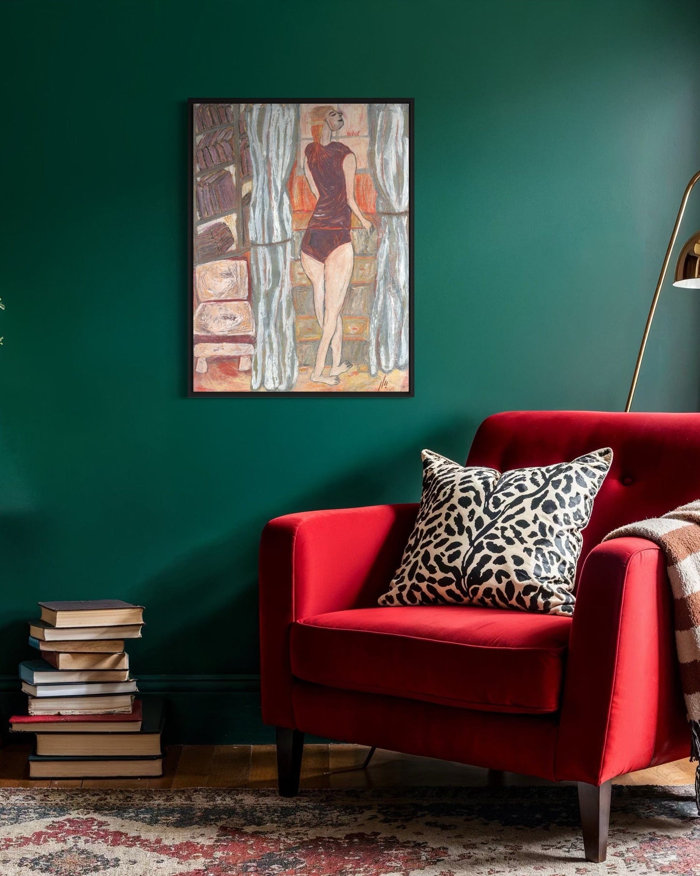 Red armchair with a leopard print pillow against a green wall with a painting.