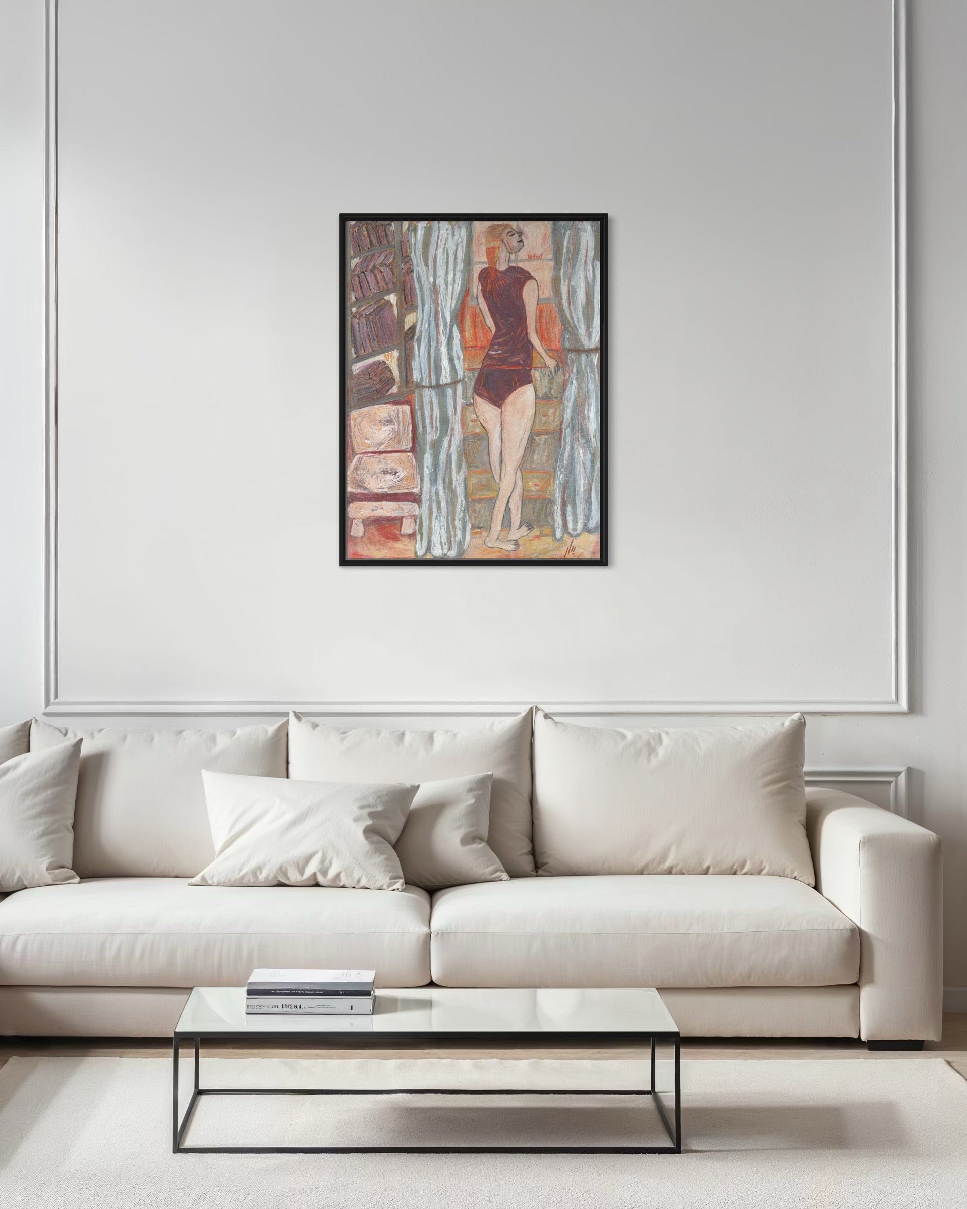 Framed abstract artwork on a wall above a white sofa in a living room.