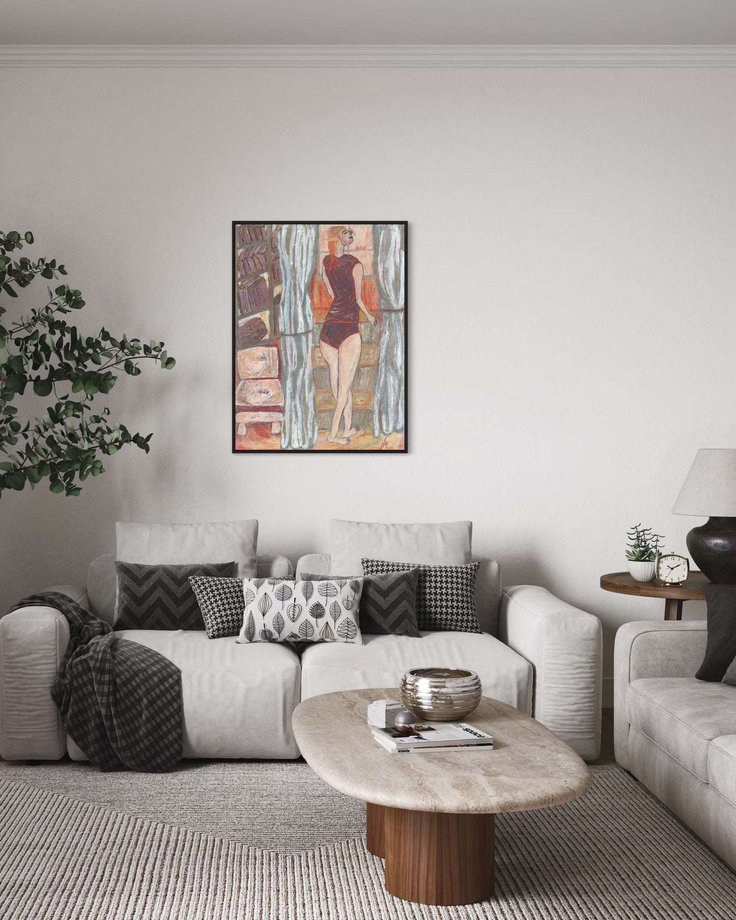 Living room with a white sofa, coffee table, and wall art.