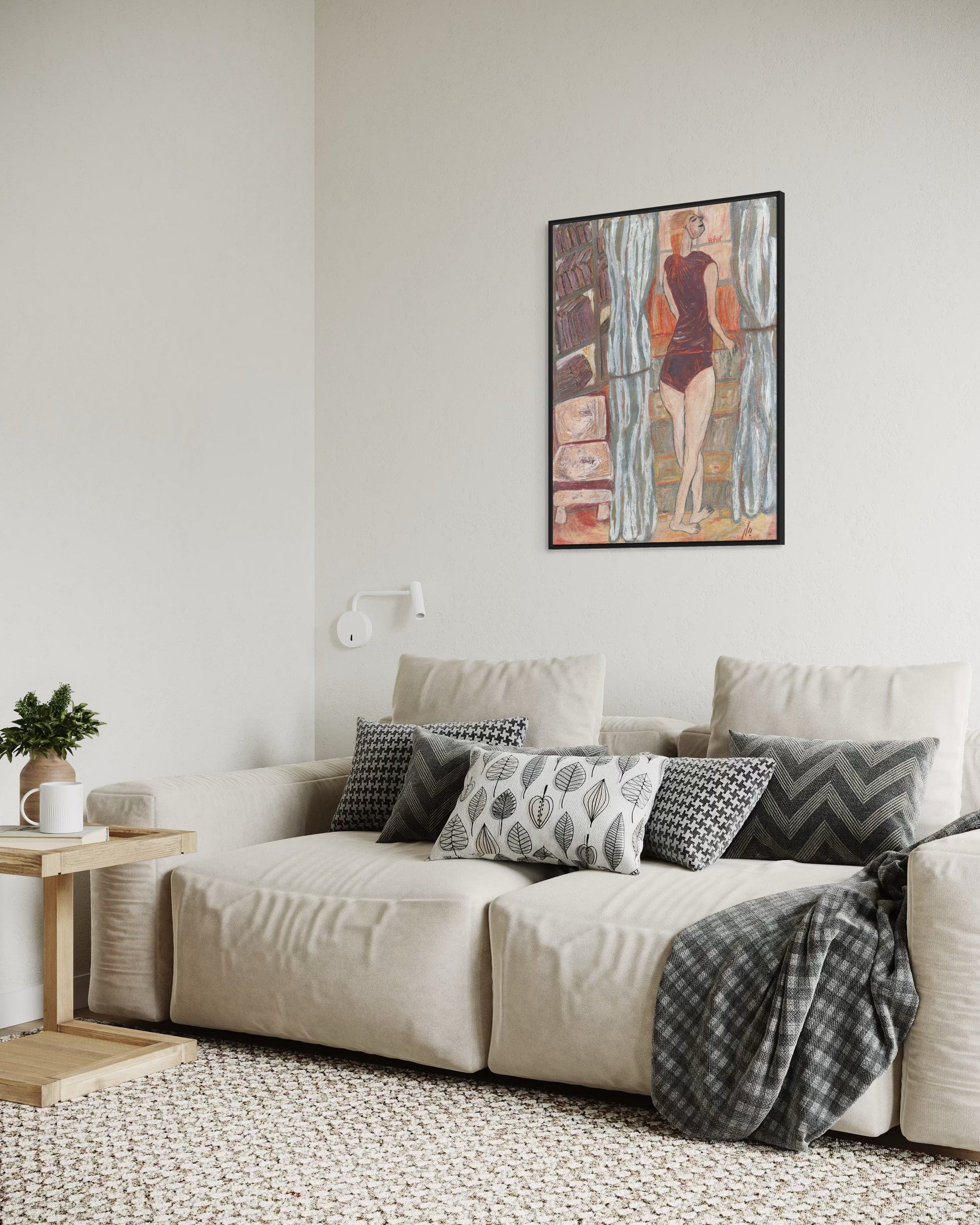 Living room with a beige sofa, decorative pillows, and a wall art piece.