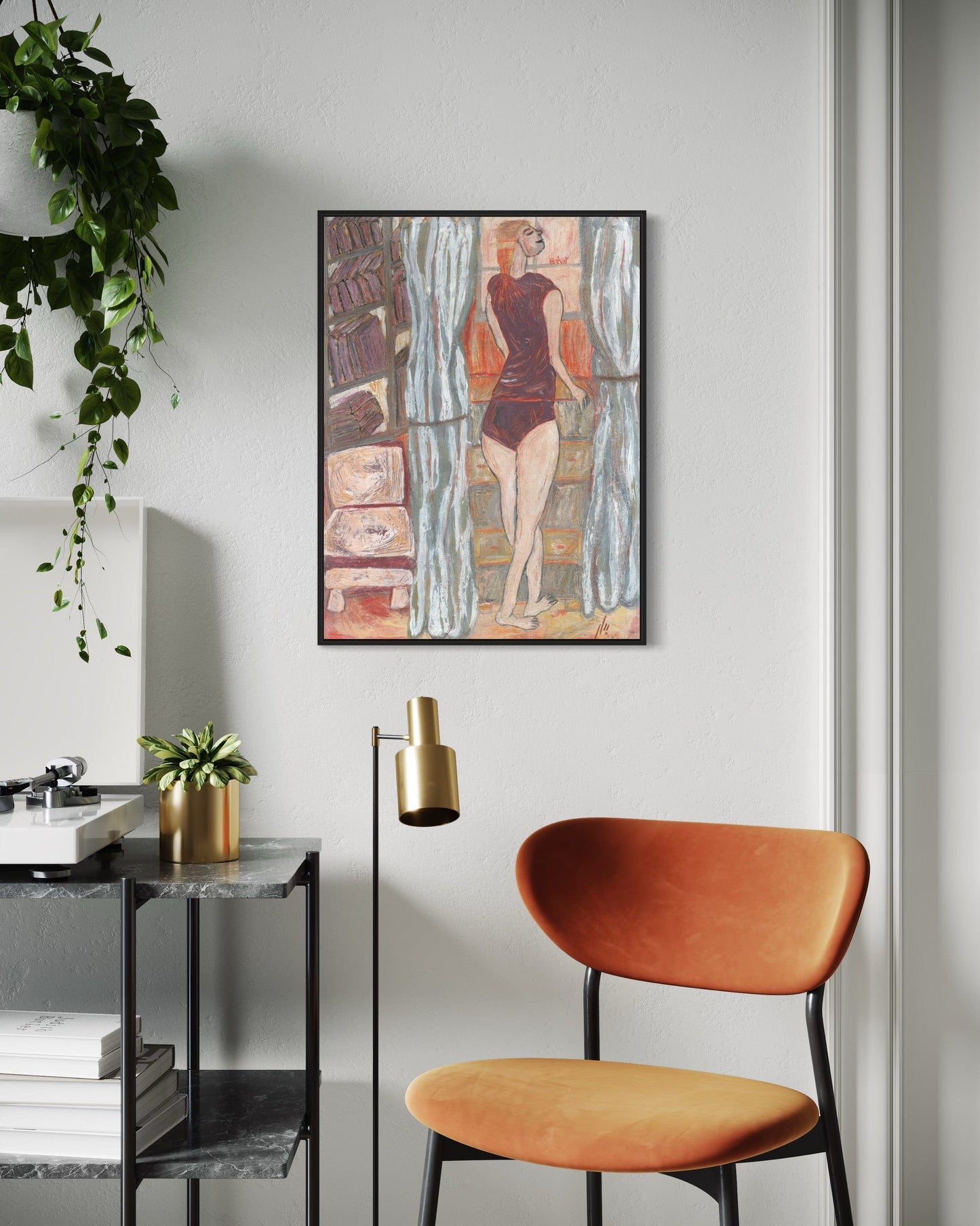 Modern interior with a framed artwork, orange chair, and decorative plants.