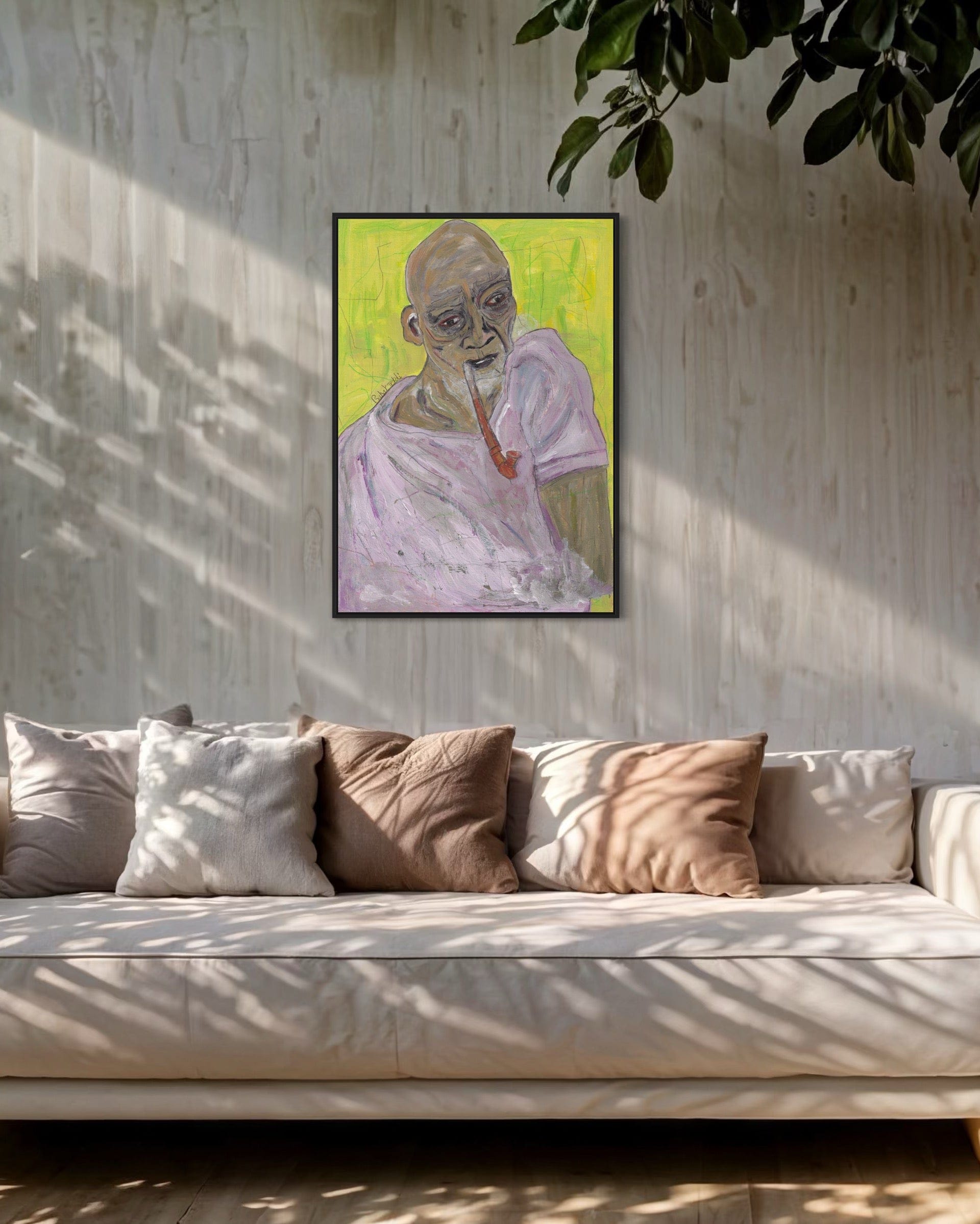 Framed artwork of a figure with a green background on a wall above a sofa.