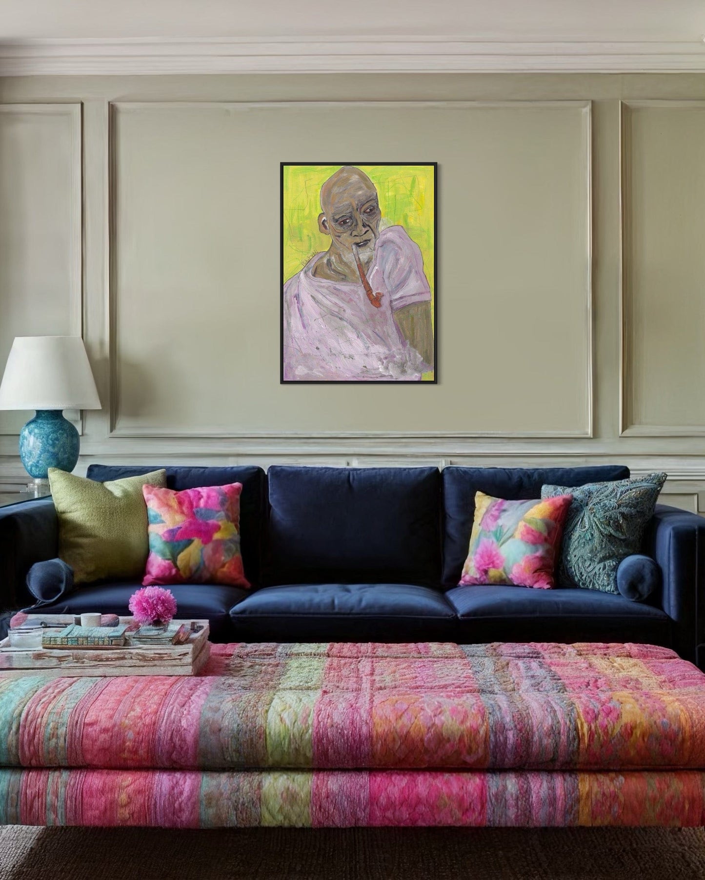Living room with a dark blue sofa, colorful cushions, and a vibrant painting on the wall.