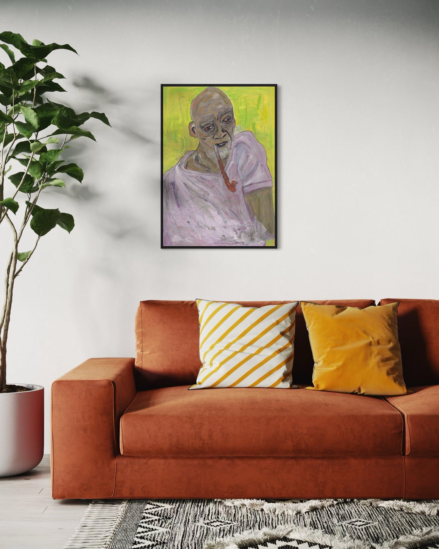 Framed painting of a man with a cigarette above a red sofa with decorative pillows.