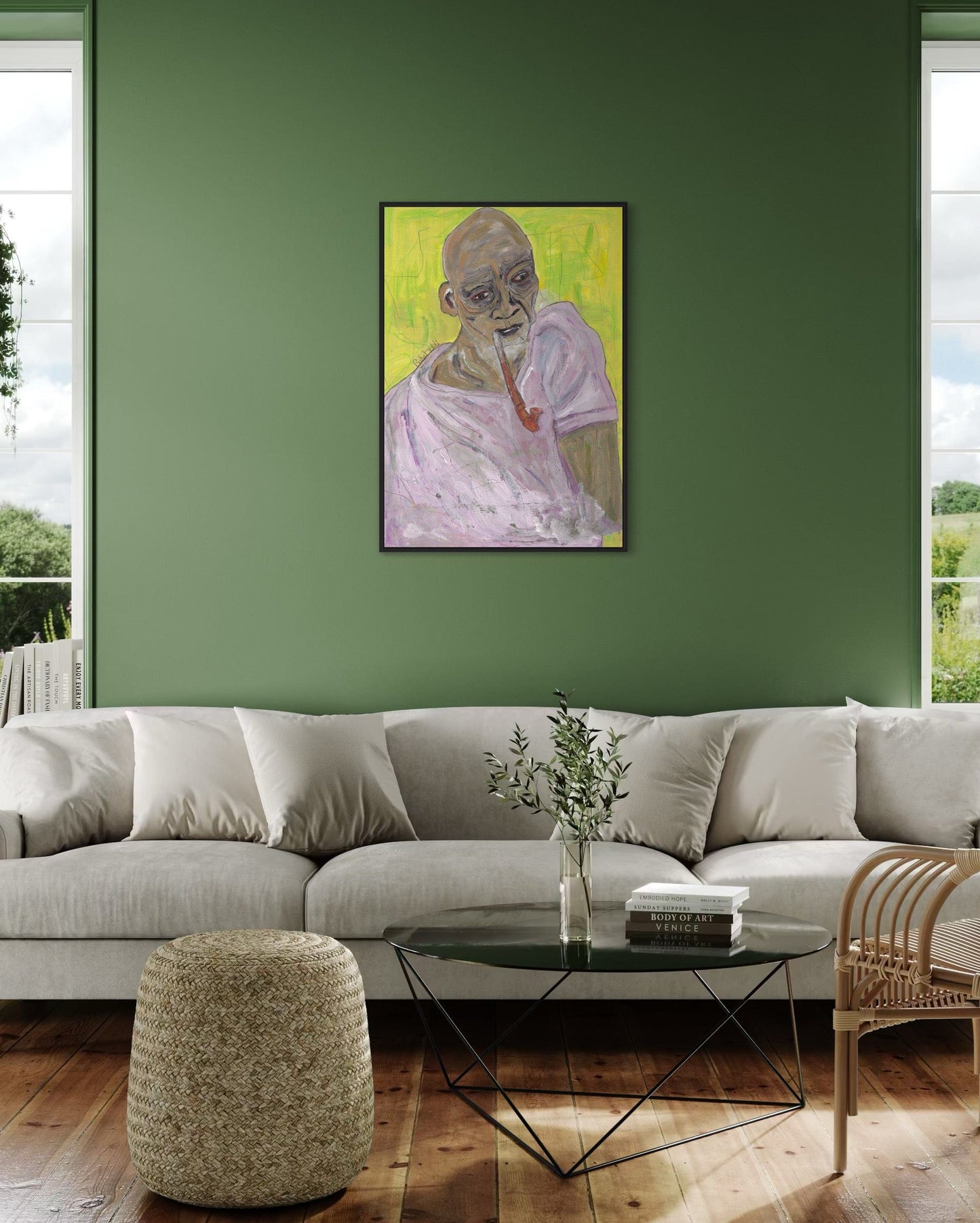 Living room with a green wall, gray sectional sofa, and a framed painting.