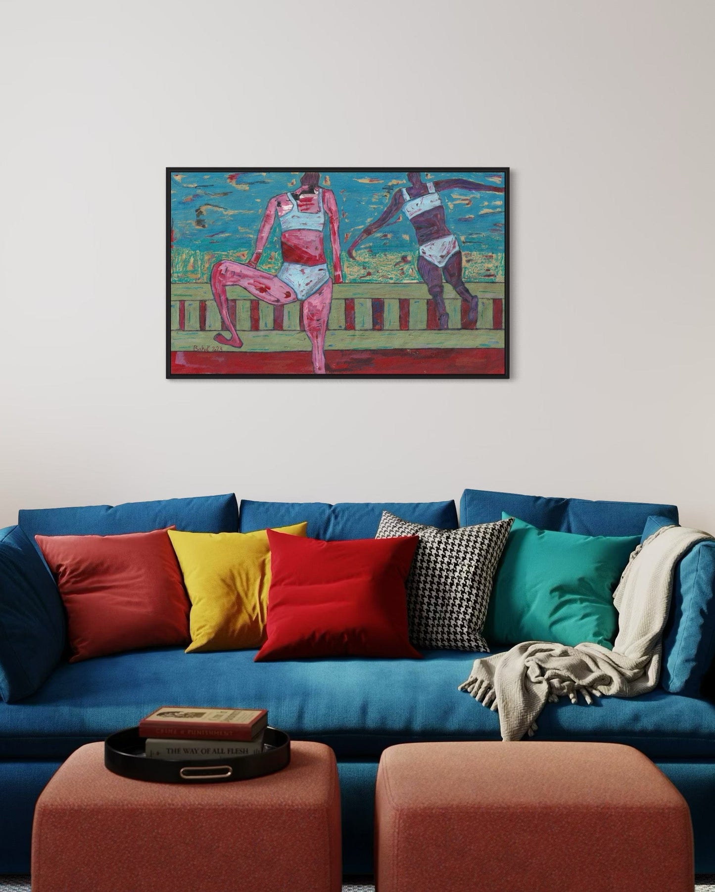 Colorful painting above a blue sofa with multicolored cushions in a living room setting.