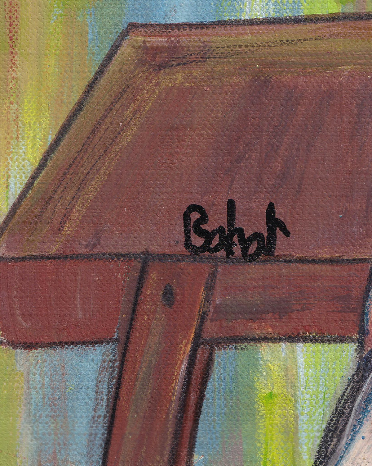Close-up of a wooden surface with a signature in black ink.