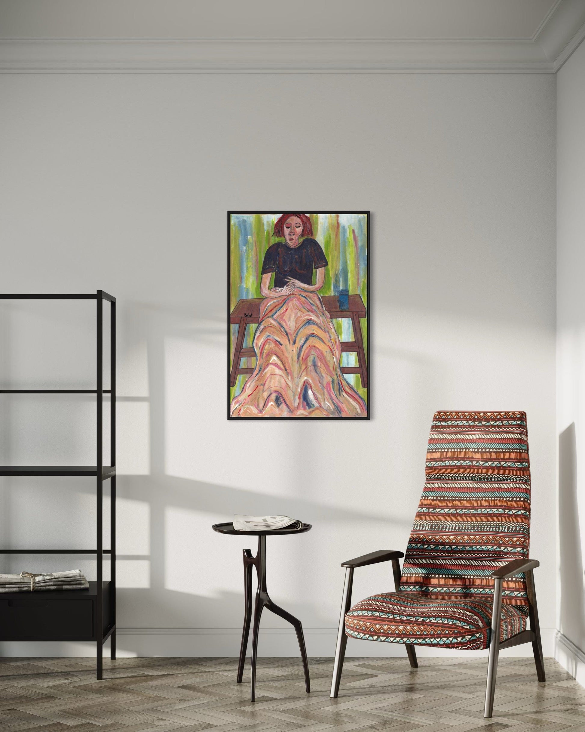 Room interior with a colorful chair, small table, and framed artwork on the wall.