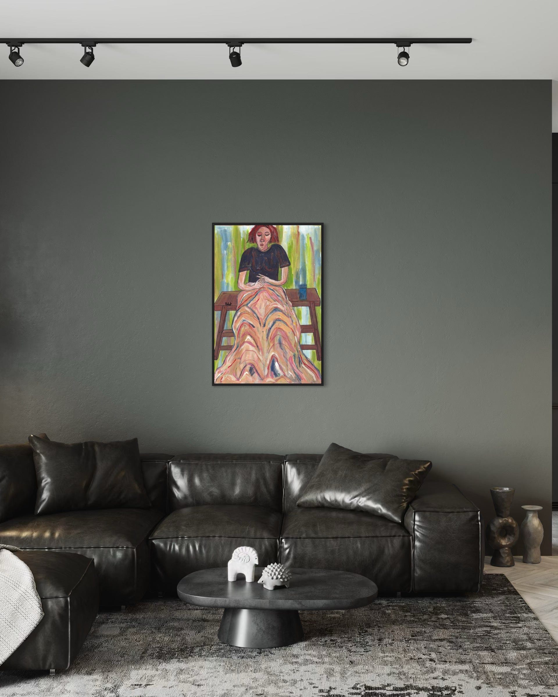 Modern living room with a black leather sofa, coffee table, and colorful abstract painting on a gray wall.