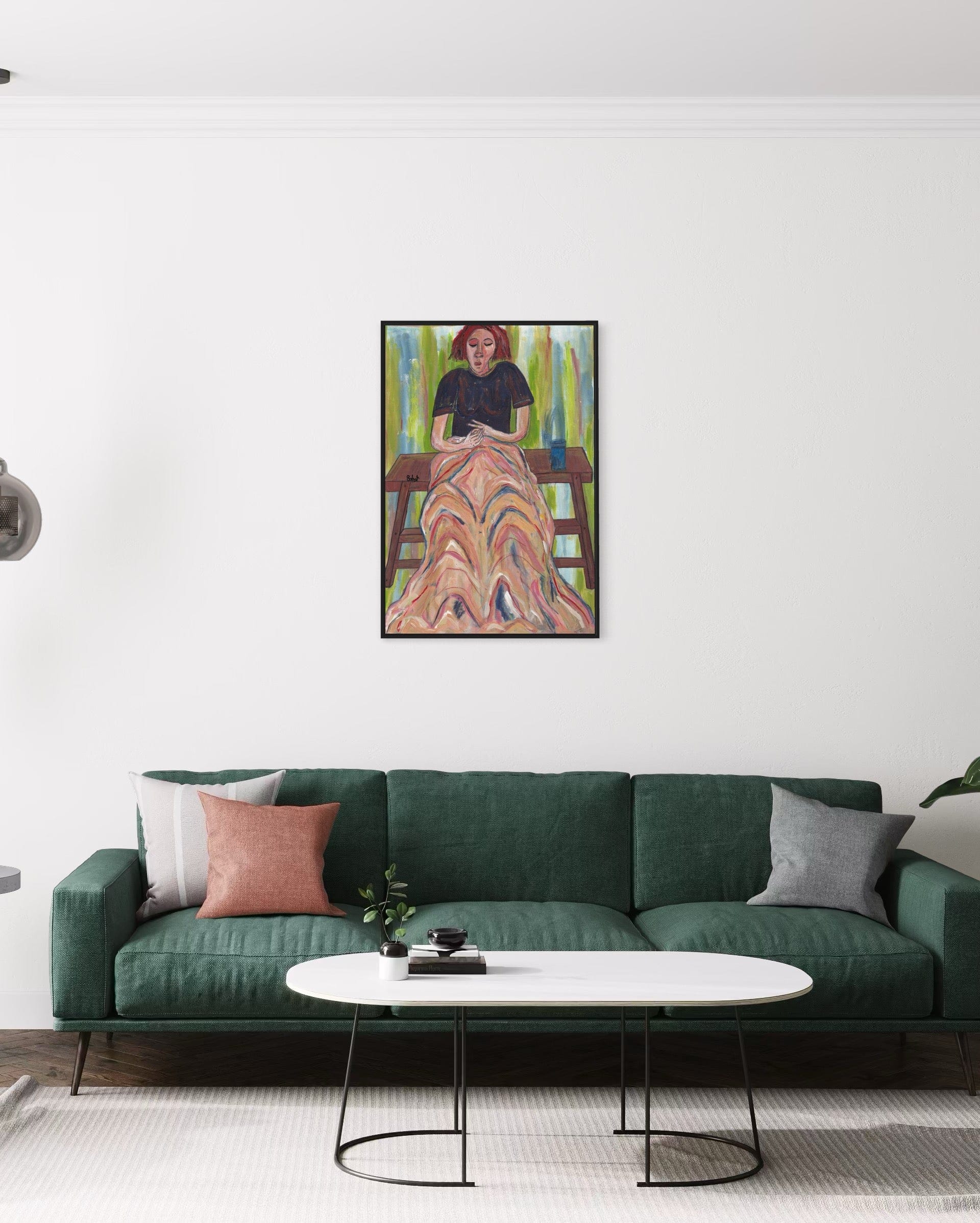 Framed artwork above a green sofa in a living room setting