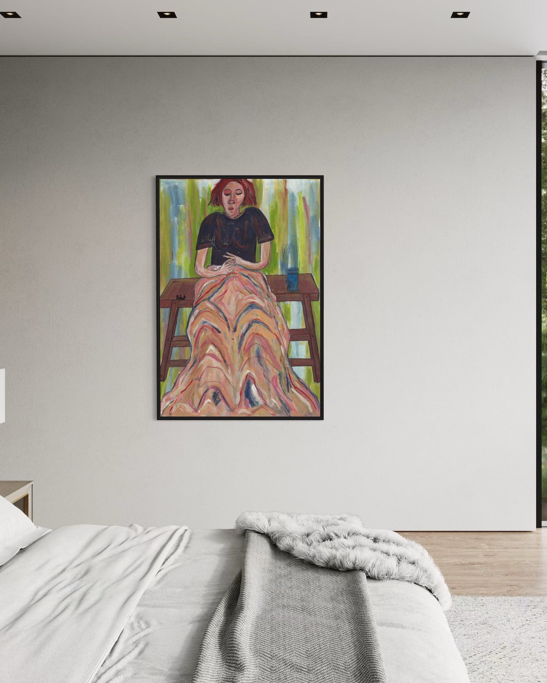 Framed artwork on a wall above a bed in a bedroom