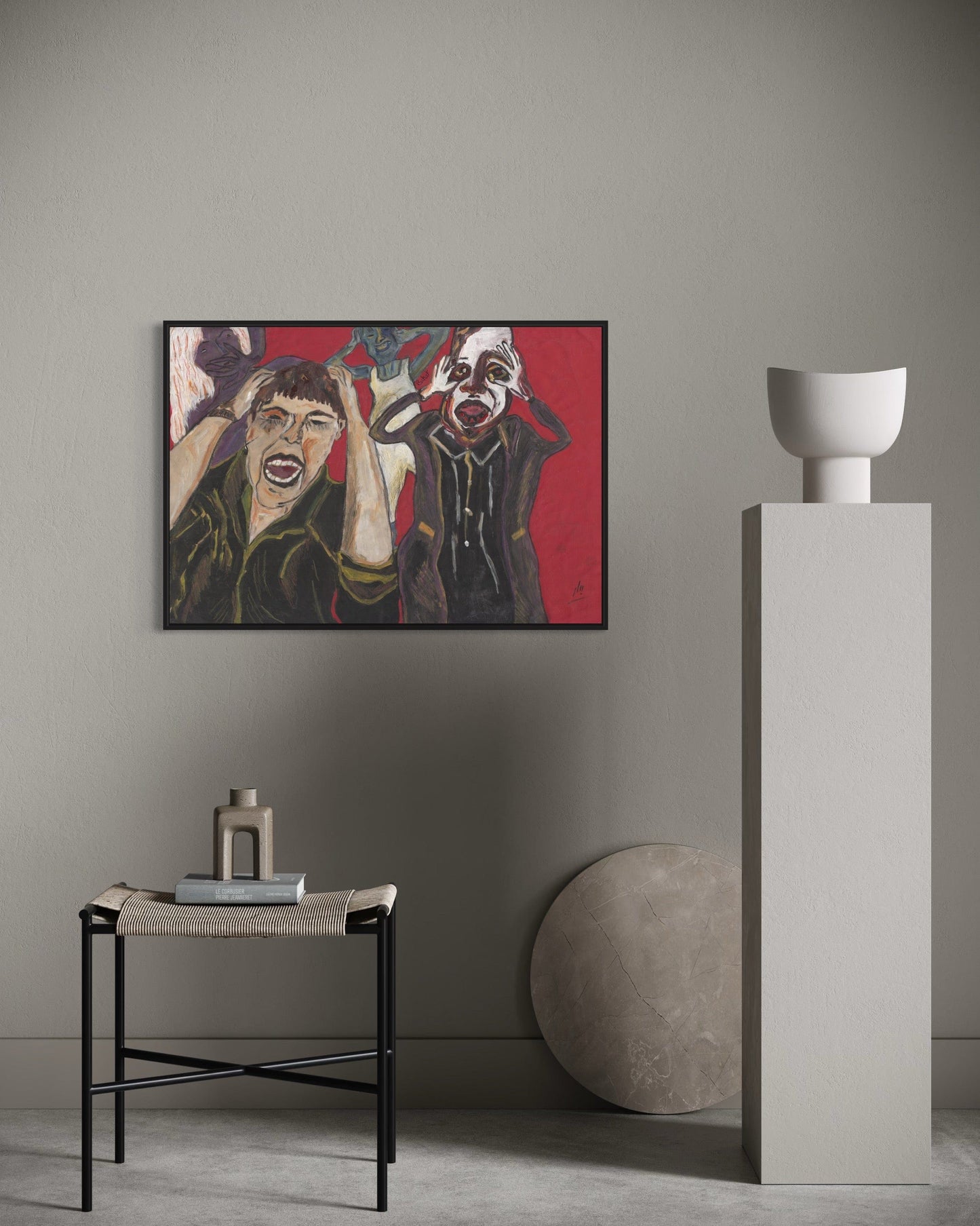 Artistic painting on a wall with minimal decor including a small table and sculpture.