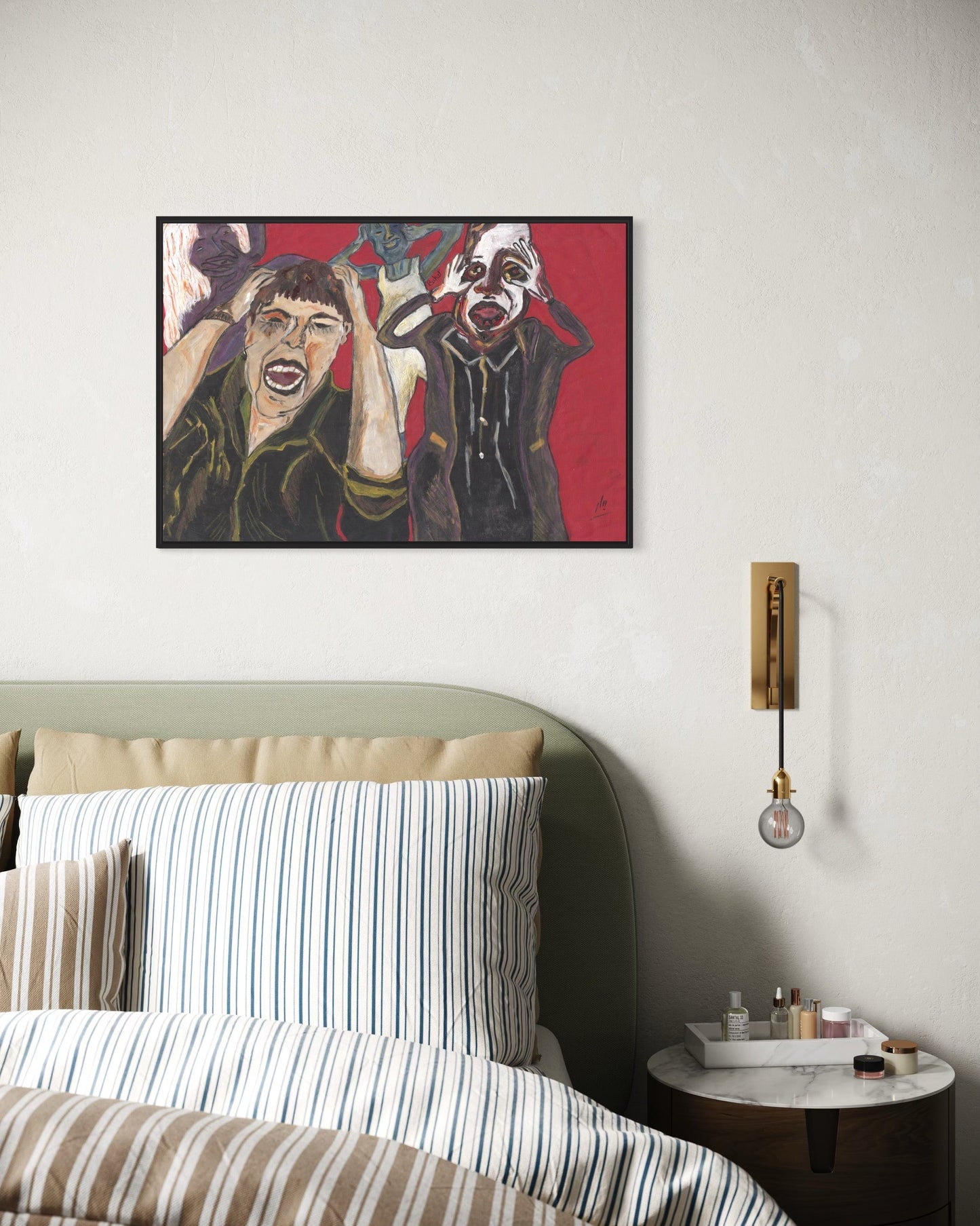 Framed artwork above a bed in a bedroom setting
