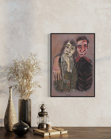 Framed artwork of two people on a wall with decorative items below.